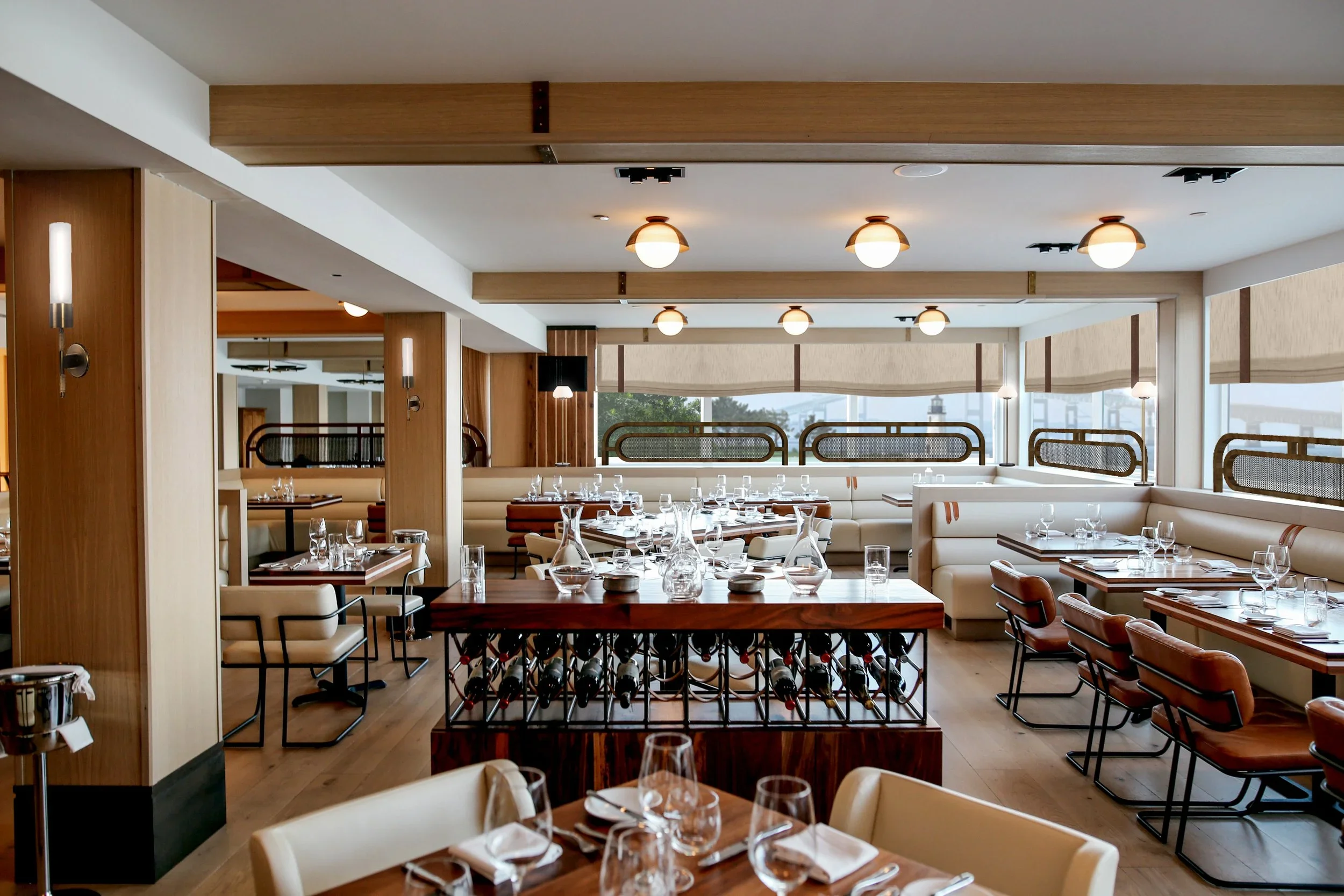Newly renovated Scarpetta Restaurant at Gurney’s Newport Resort and Marina, featuring modern lighting, a clean and elevated aesthetic, and endless views to the harbor.