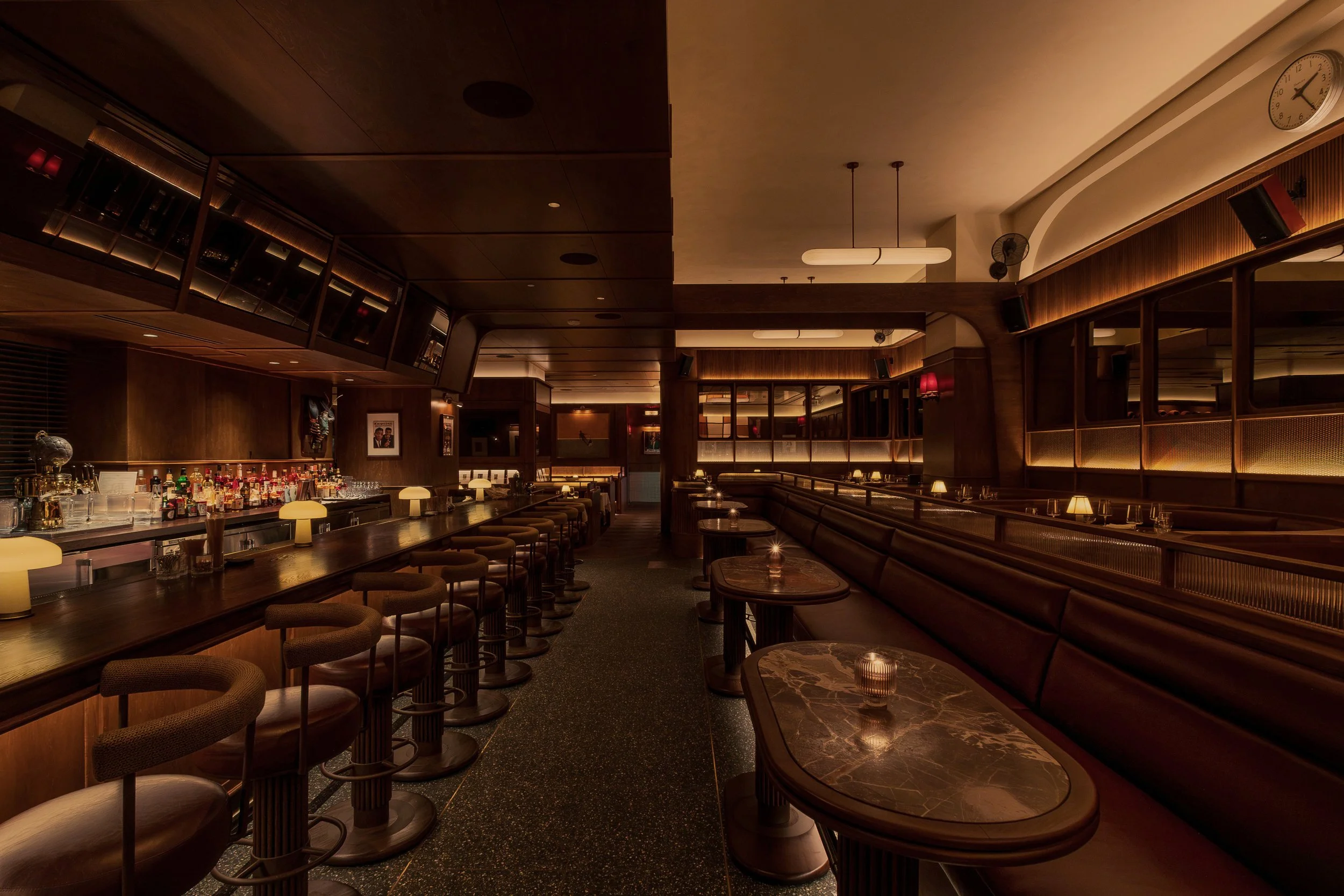 A sweeping view of Austin Sports Club’s bar and dining room reveals layered seating, integrated televisions and warm club-inspired finishes.