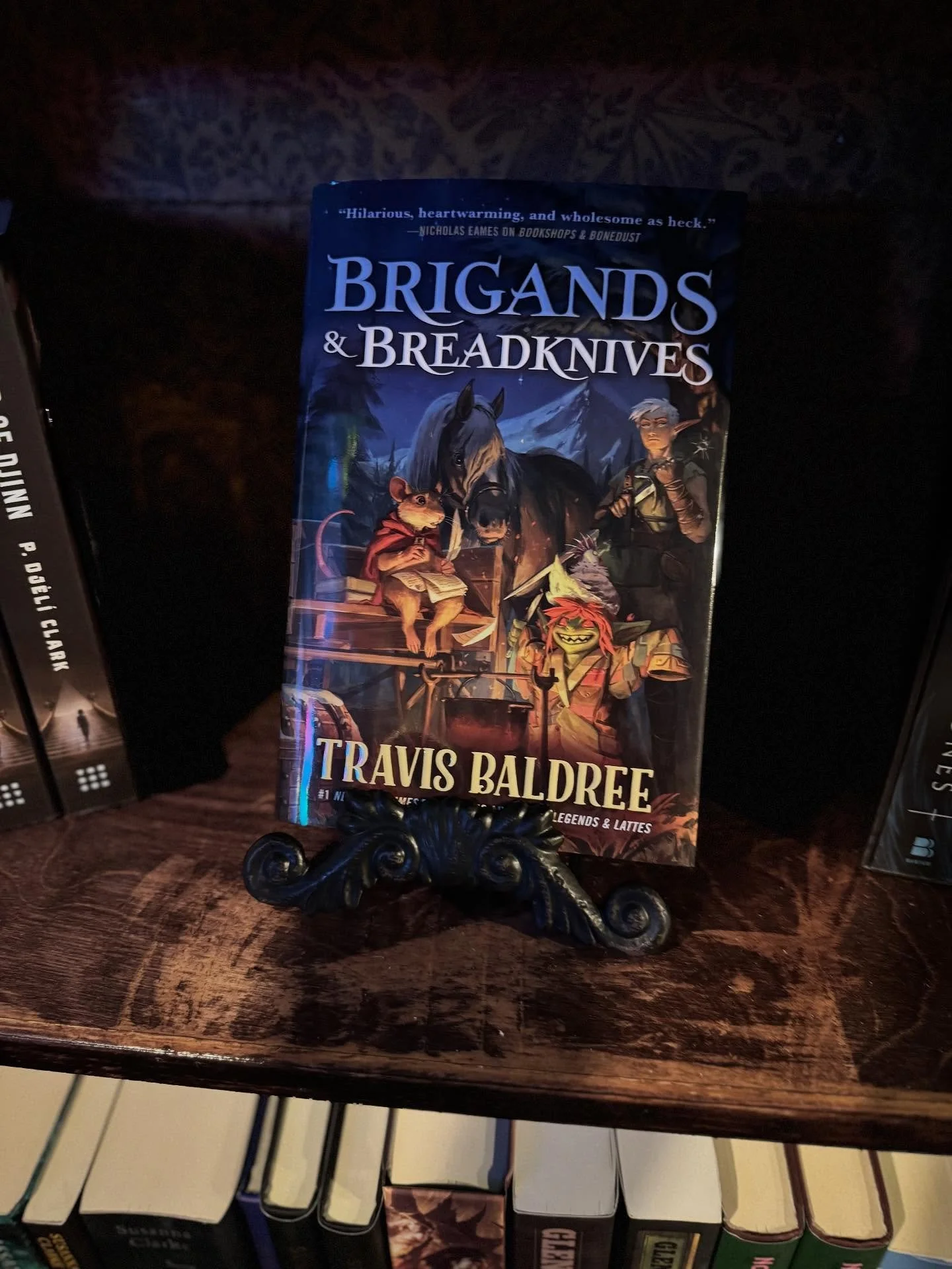 NEW IN THE BOOKSHOPPE! ✨🪩✨

🥖 Brigands &amp; Breadknives by Travis Baldree
🧿 1984 by George Orwell&mdash; both original and comic book!
🧟 Death Warmed Over by Kevin J Anderson
🐲 Roll for Romance by Lenora Woods
🌌 The Tatami Galaxy by Tomihiko M