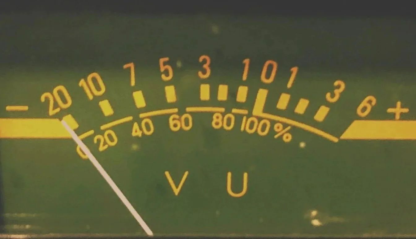 Analog voltmeter gauge with yellow markings, displaying a voltage of approximately 10 volts and a current of about 1.3 amperes.