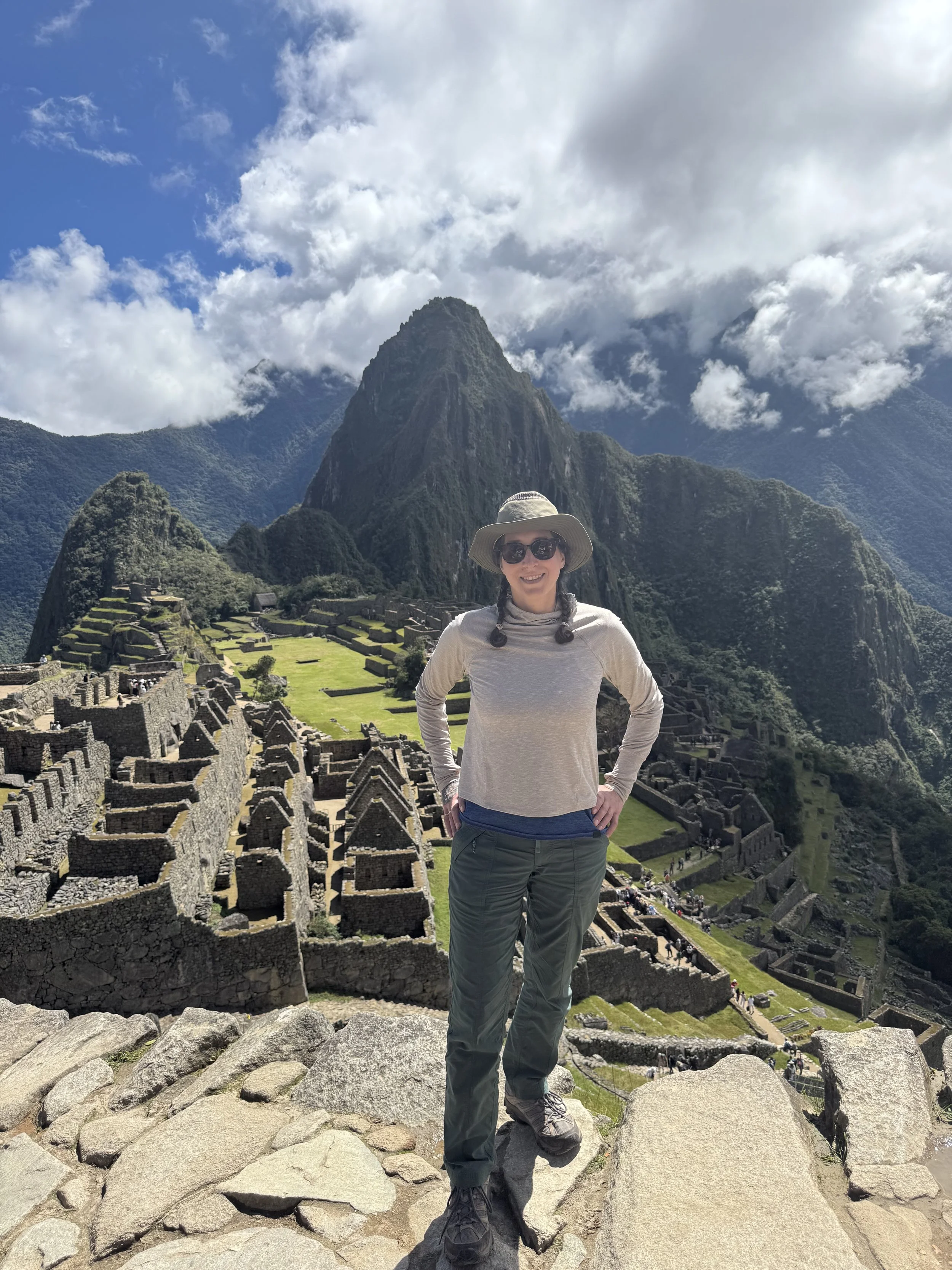 Alix posing for the camera with Machu Picchu behind