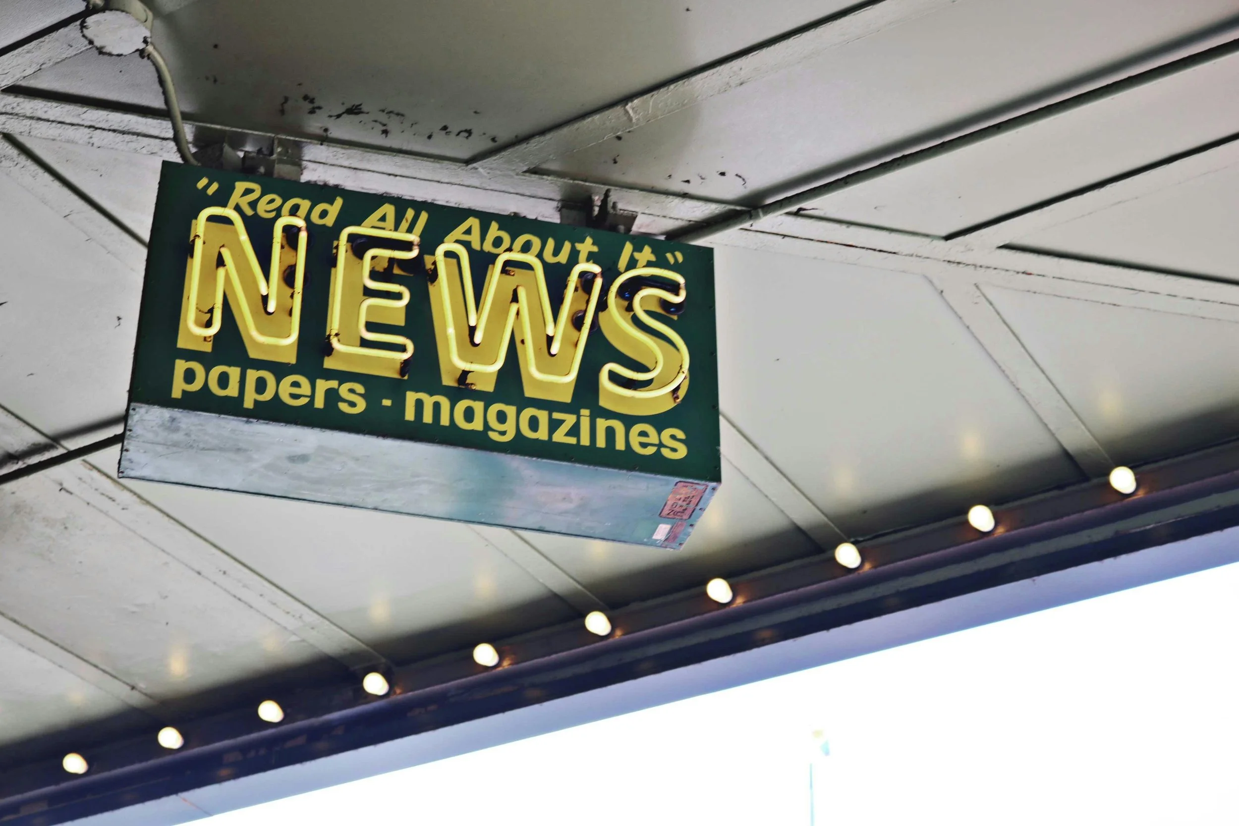 Stock image of a news sign, which reads: "Read all about it" News - papers - magazines.
