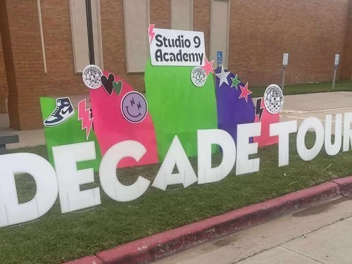 First day of kindergarten yard sign with pencils and books in Lubbock