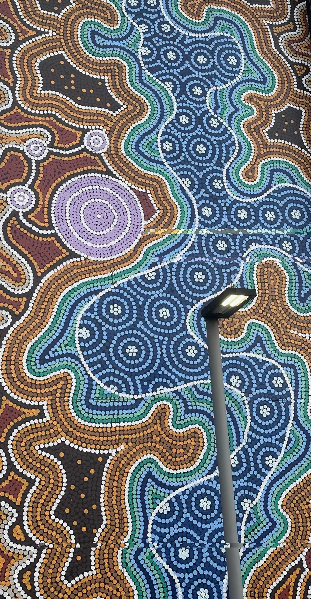 Aboriginal painting with light post in front