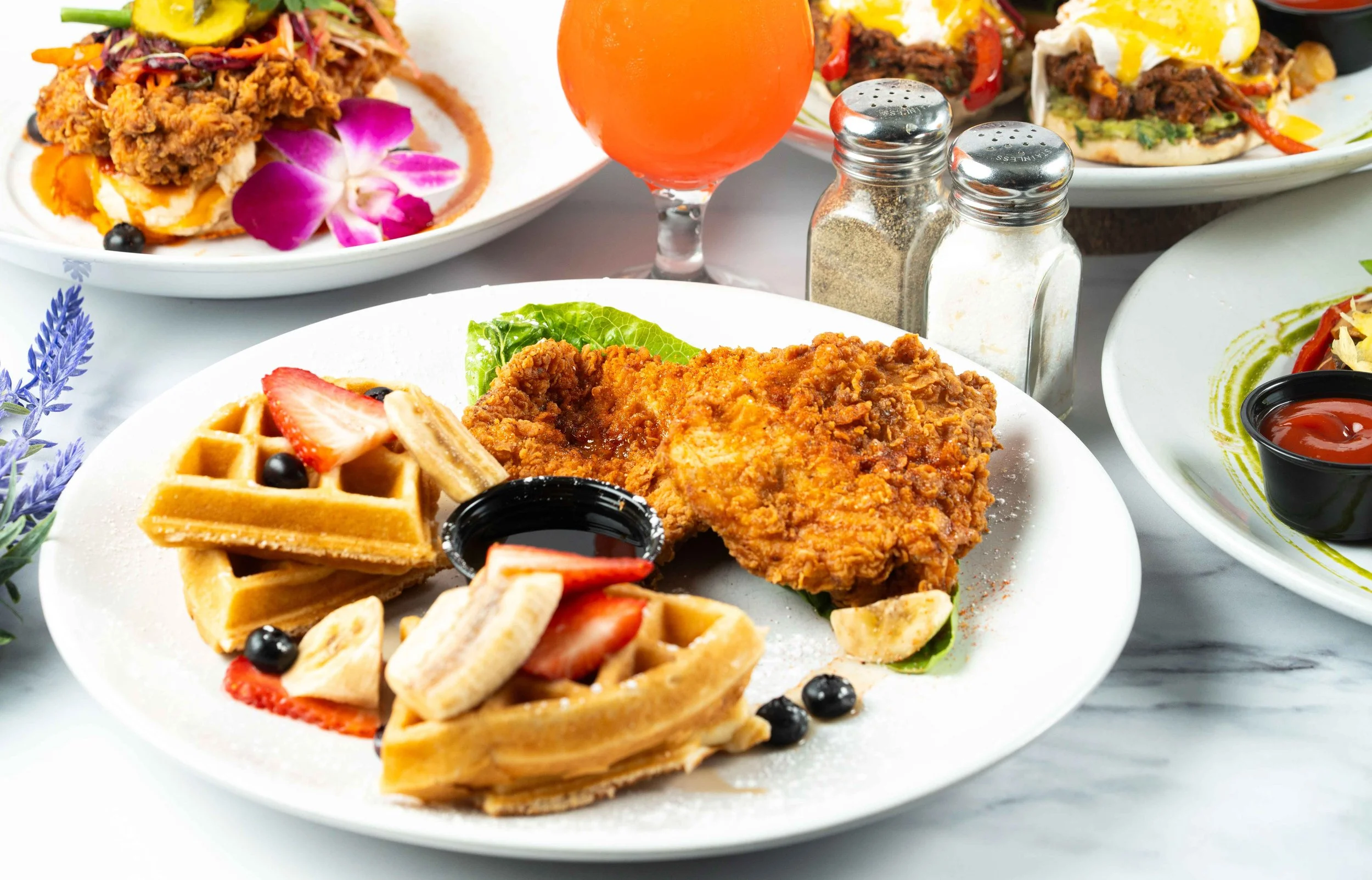 Crispy chicken and Wffles topped with berries.
