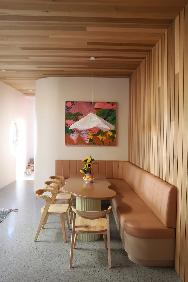 Wide shot of midcentury modern dinette and abstract hung artwork