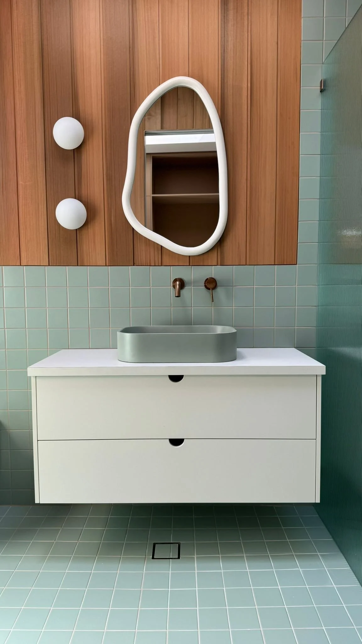 Midcentury modern aqua tile and wood backsplash ensuite