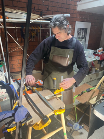 Richard Lloyd restoring timber furniture in his workshop