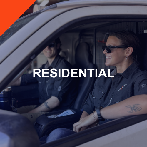 A woman and a man smiling inside a vehicle, with the woman in the driver's seat wearing sunglasses and a dark shirt. The word 'RESIDENTIAL' is overlaid on the image.