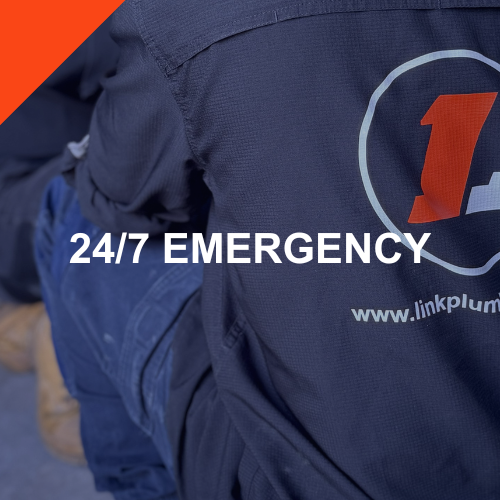 Close-up of a person wearing a navy jacket with a logo and text '24/7 Emergency' and a website link 'www.linkplum'.