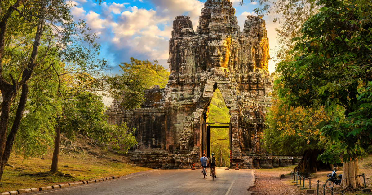 Cyclists approaching the south gate of Angkor Thom near Siem Reap