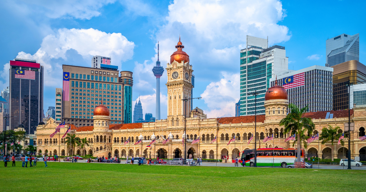The Sultan Abdul Samad Building and Merdeka Square in Kuala Lumpur with the KL Tower and city skyline behind