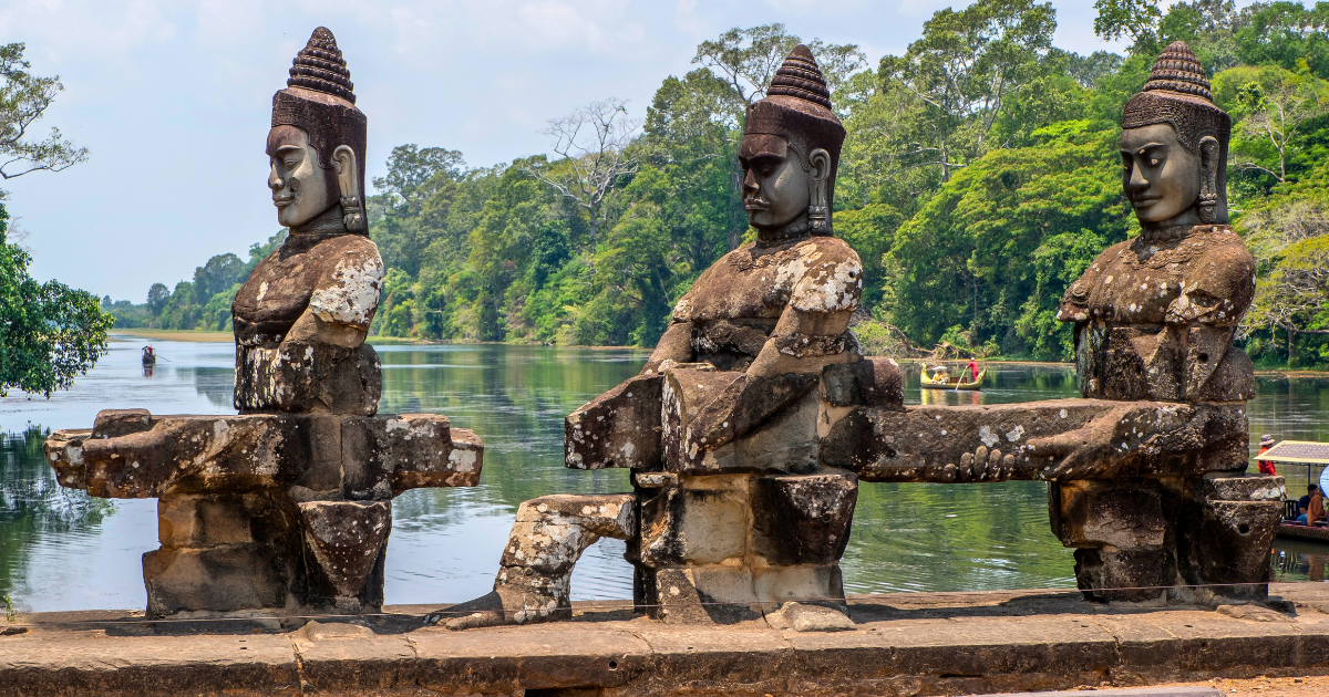 Stone deity statues lining the bridge approach to the south gate of Angkor Thom
