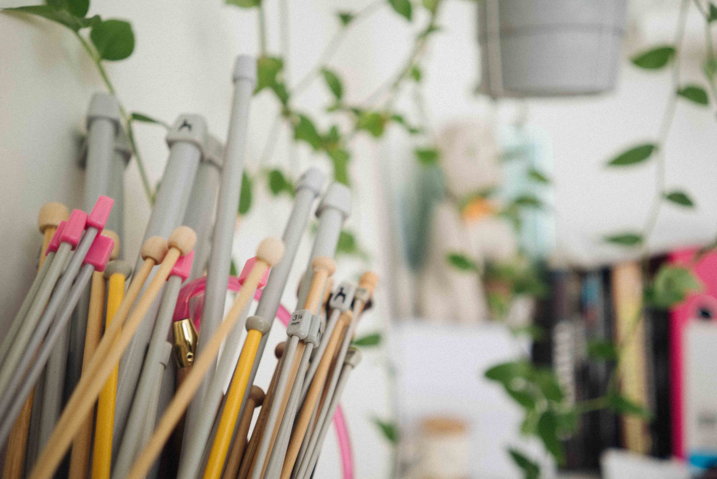 A selection of wooden and plastic knitting needles