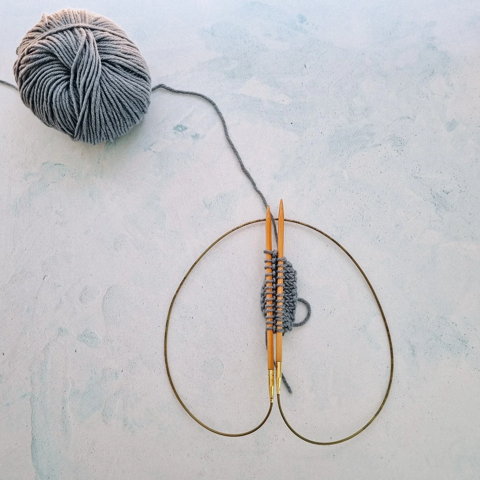 Blue Knitting on wooden circular needles using the Magic Loop Method