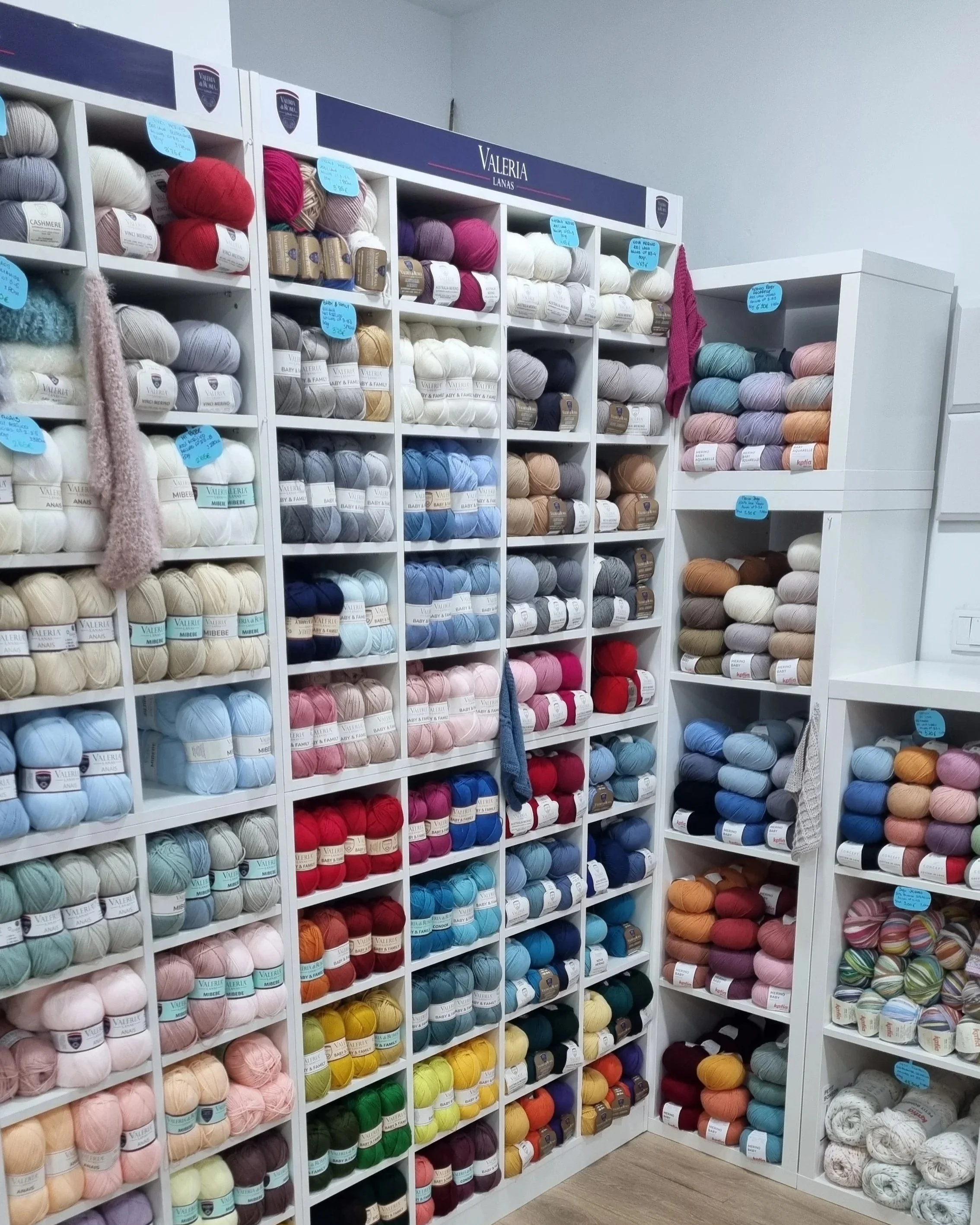 White shelves filled with knitting yarn in a store