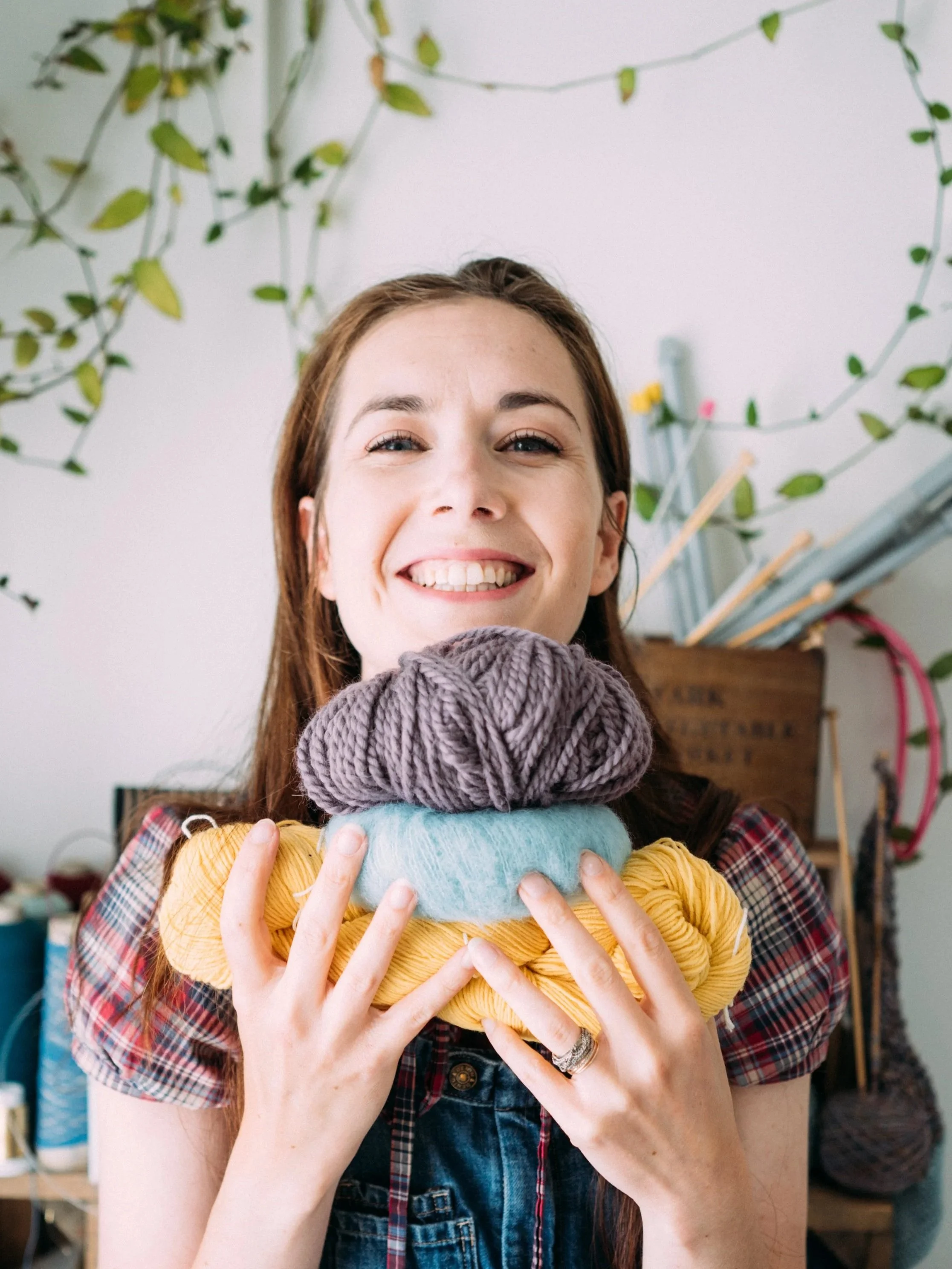 Knitting Teacher Alice with a stack of different coloured yarn
