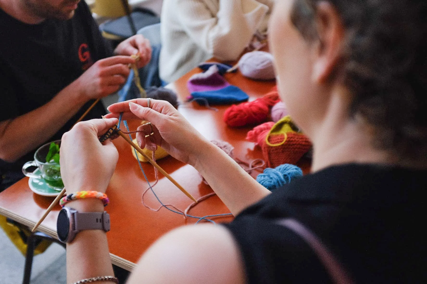 Knitting Teacher Alice demonstrates to a beginner knitting student