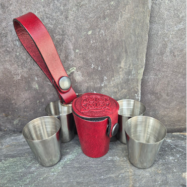 Red Leather Whisky cup holder with stainless steel cups beside it