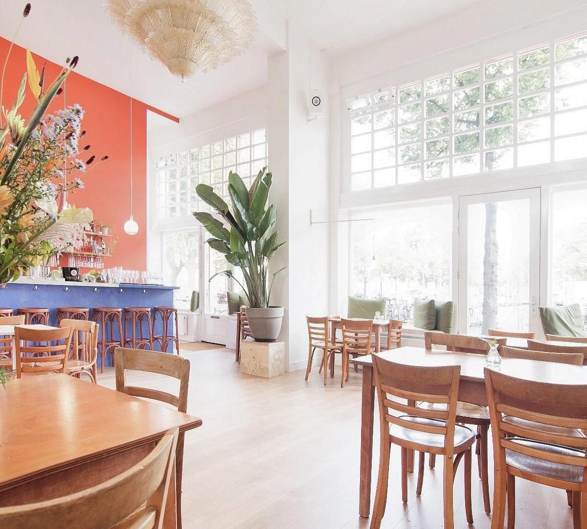 Tables and Chairs sit in a bright cafe space
