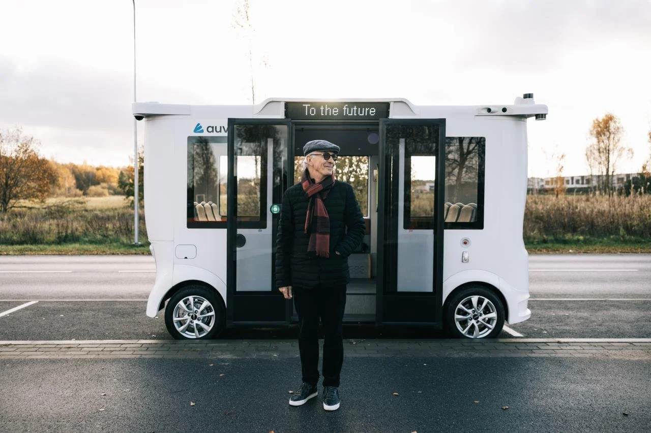 Man standing in front of self-driving bus.jpeg
