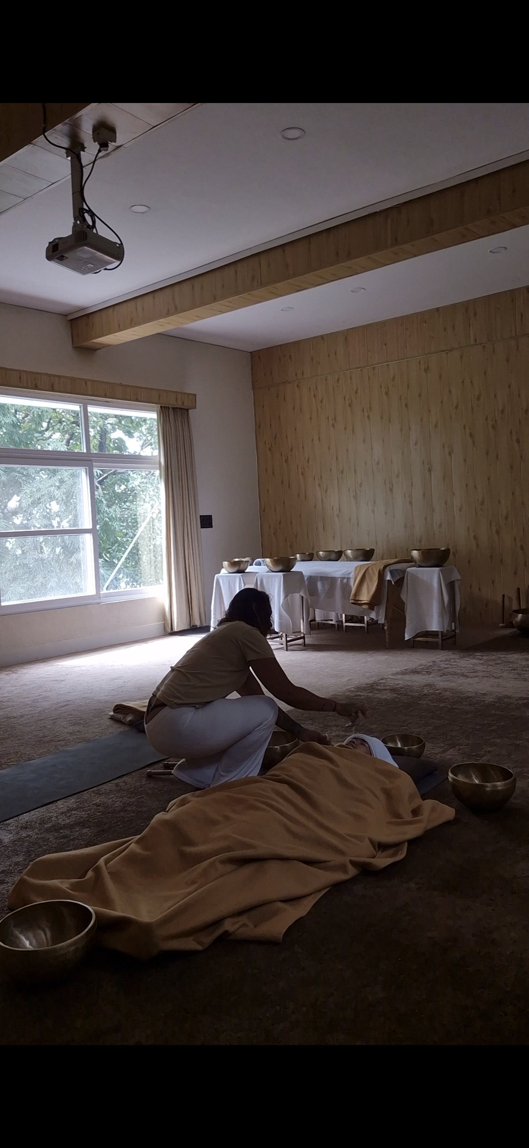 1:1 Sound Healing treatment taking place on the floor