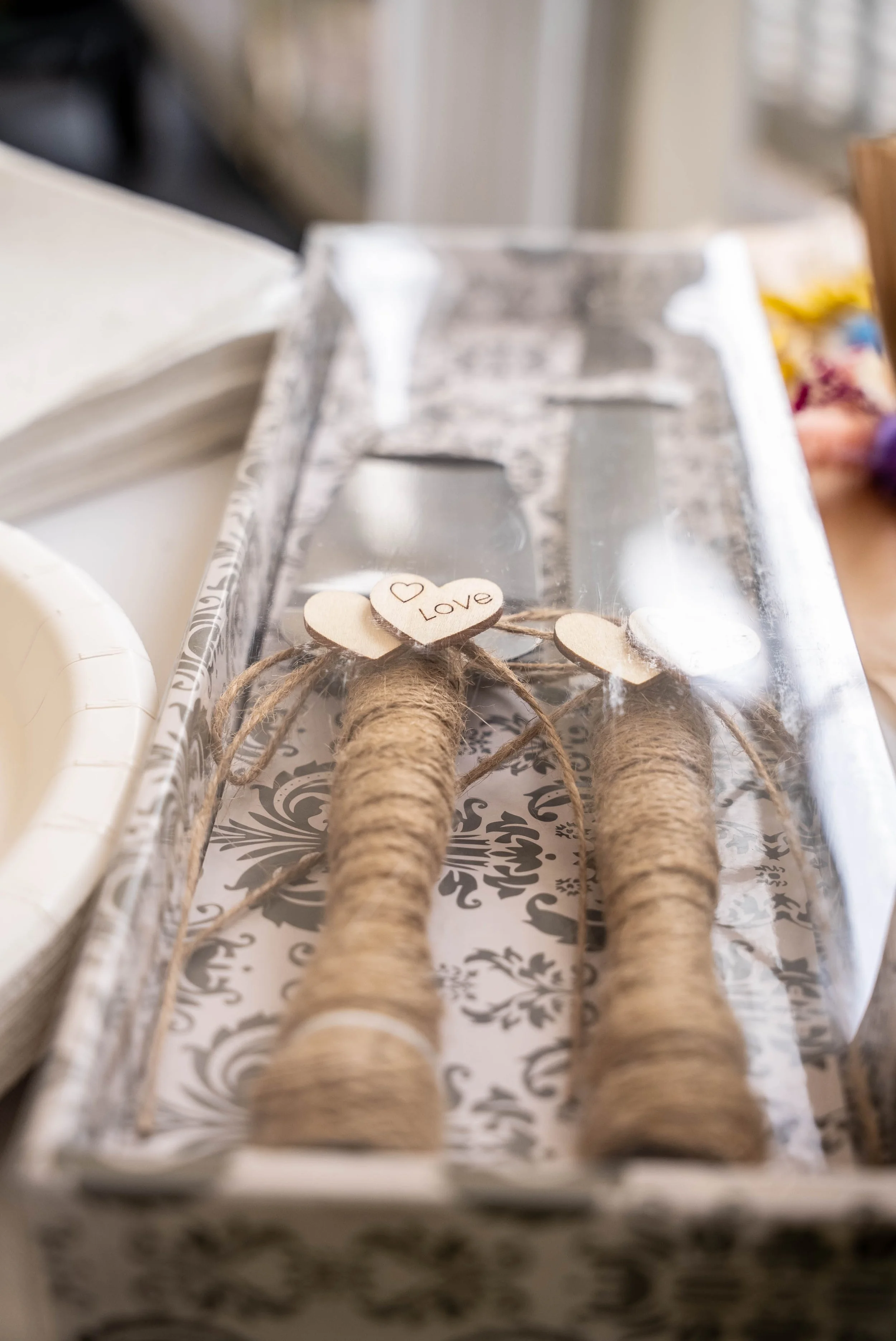 Decorative magic wand with a wooden heart labeled "Love" on a tray.