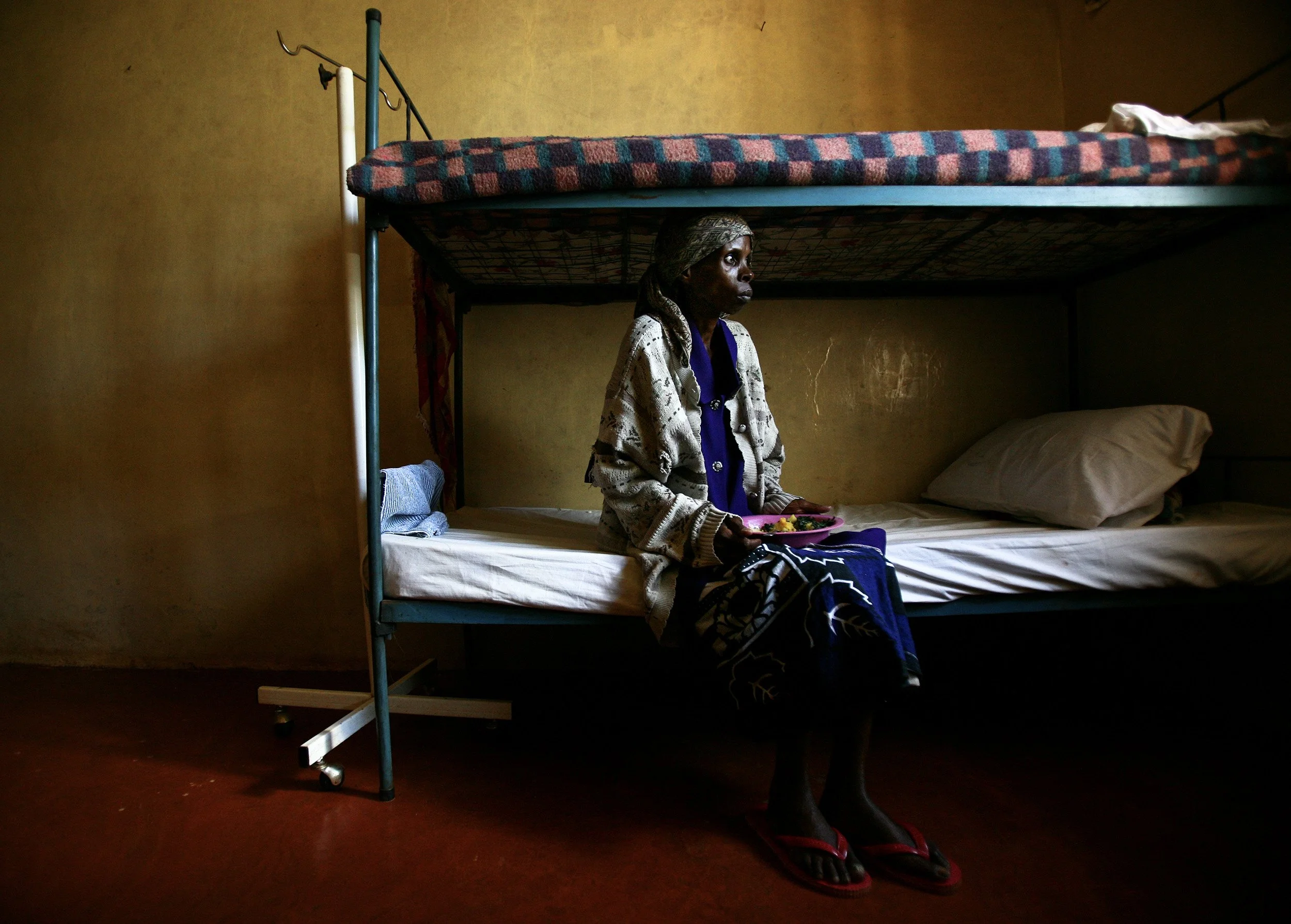 Meru, Kenya-28 November 2006: Elisabeth Mweru,28, feeding herself again for the first time in weeks as she recovers from severe tuberculosis. Elizabeth was found in an advanced stage of full blown Aids by a group of self-supporting HIV+ women in her