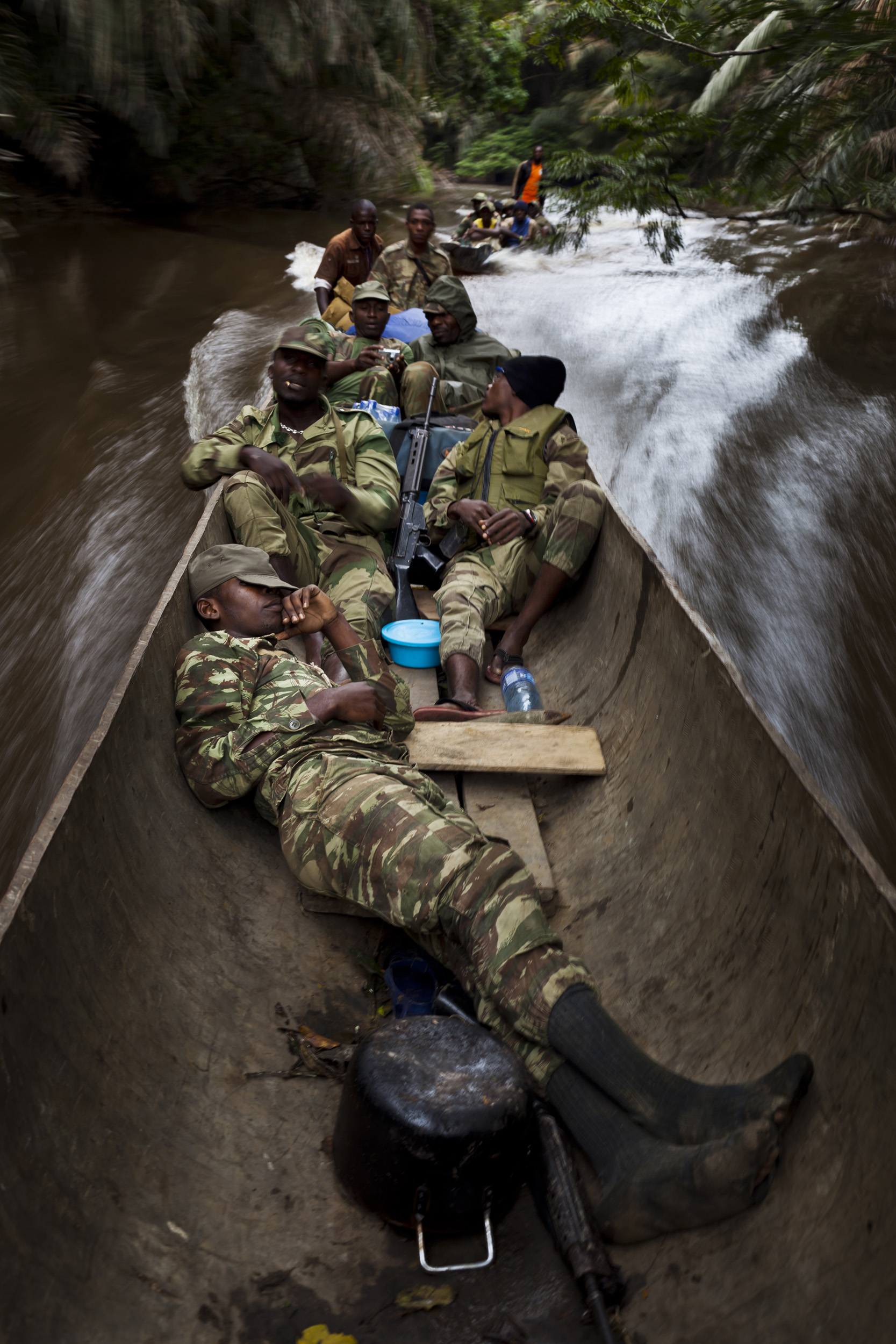 SING RIVER, MINKEBI NATIONAL PARK, GABON, JUNE 2011: An anti-poaching team composed of Gabon Parcs personal, Gabon military, Baka pygmy porters and two Pirouge pilots conduct an anti-poaching mission up the Sing River in Minkebi National Park, Gabon