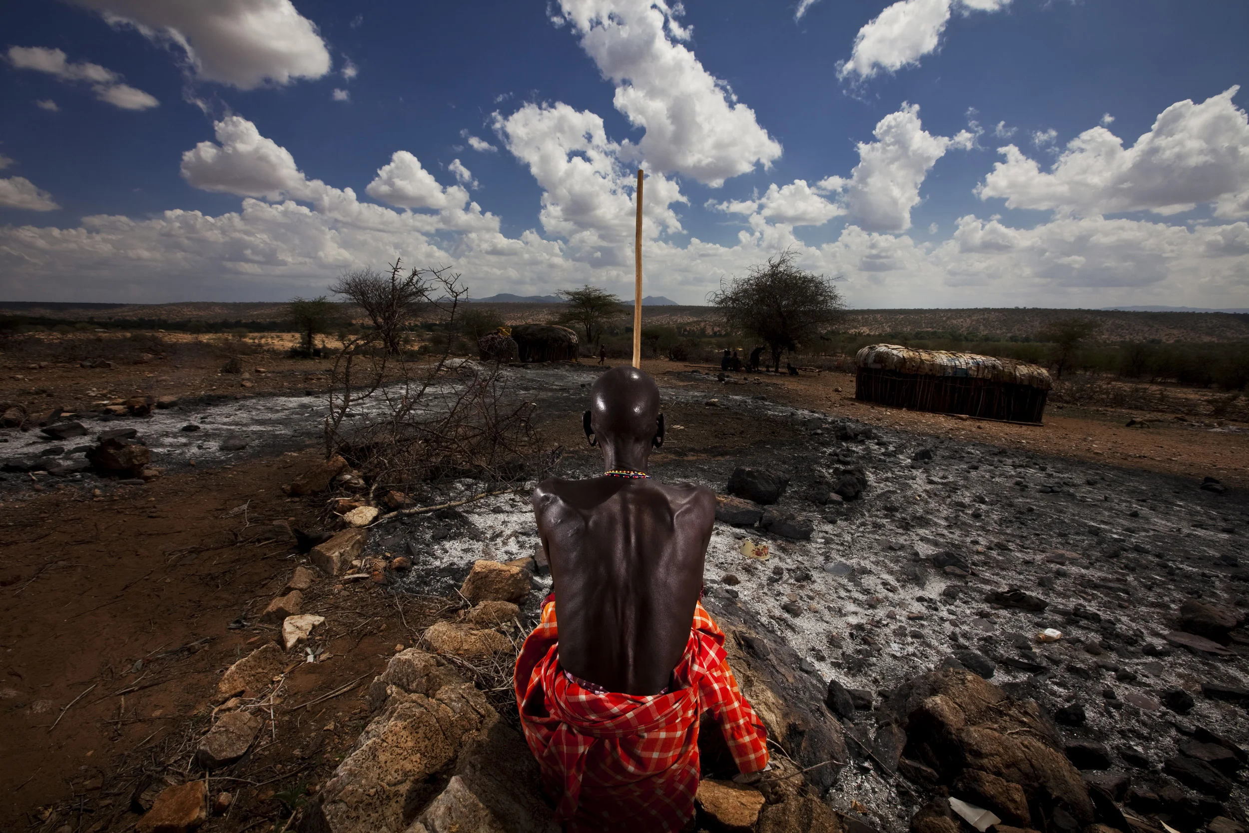 RIFT VALLEY PROVINCE, KENYA, NOVEMBER 2009: An emaciated Samburu Elder pastoralist stands in his burnt-out cattle boma at at time of the worst drought in Kenya for the last 100 years, 20 November 2009. It is traditional for the Samburu and other pa