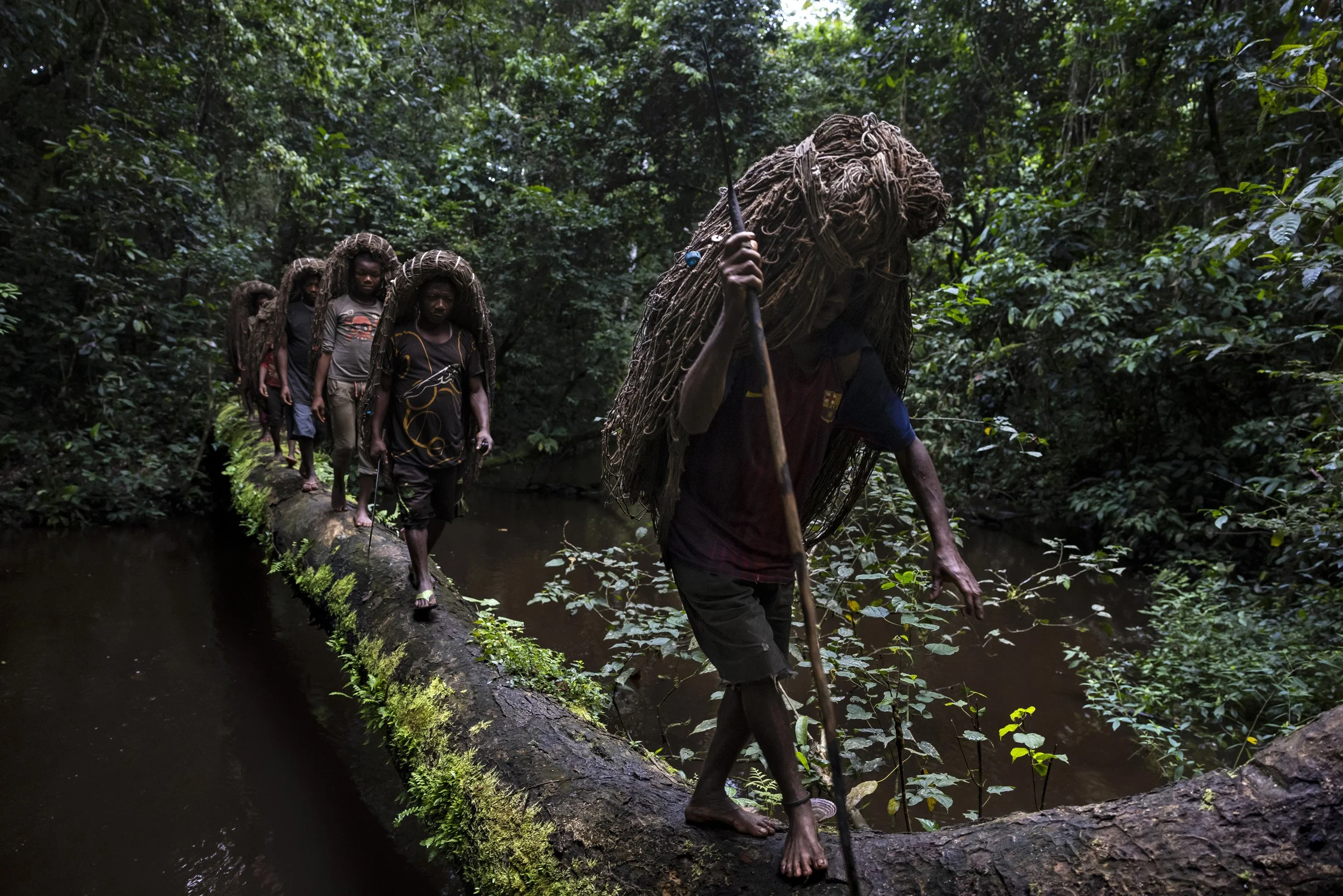 18. EPULU, ITURI, DEMOCRATIC REPUBLIC OF CONGO: An Mbuti Pygmy hunting group is seen on their way to hunt inside the forest in Okapi National Reserve. The Mbuti hunt wild meat in a sustainable manner, using nets they have created from forest vines.