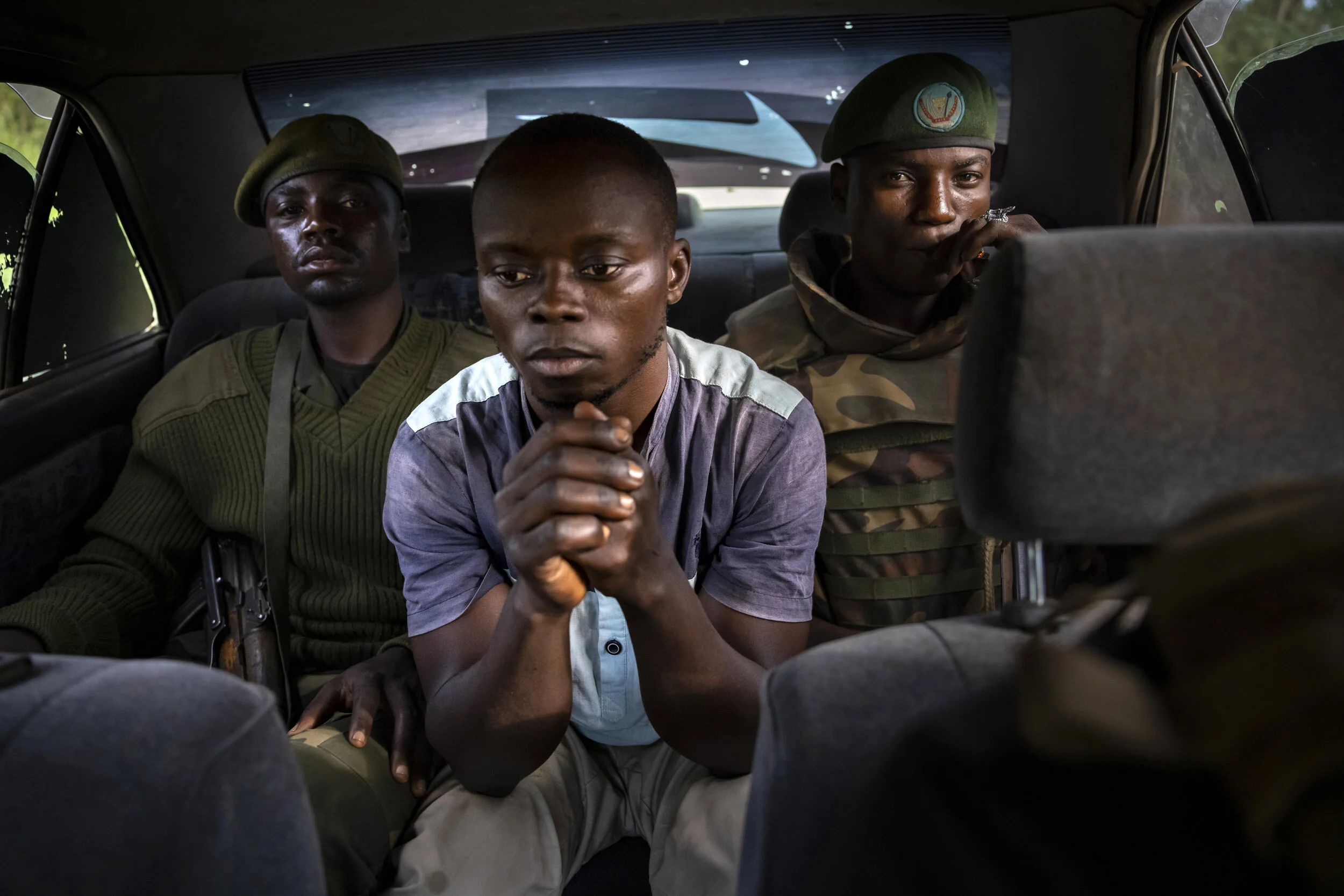 KASINDI, DEMOCRATIC REPUBLIC OF CONGO, 4 APRIL 2021: A Congolese man who is a suspected collaborator with Islamic terror group, the ADF, is seen under arrest in a vehicle on his way to interrogation by the Congolese army. He was named by two recentl