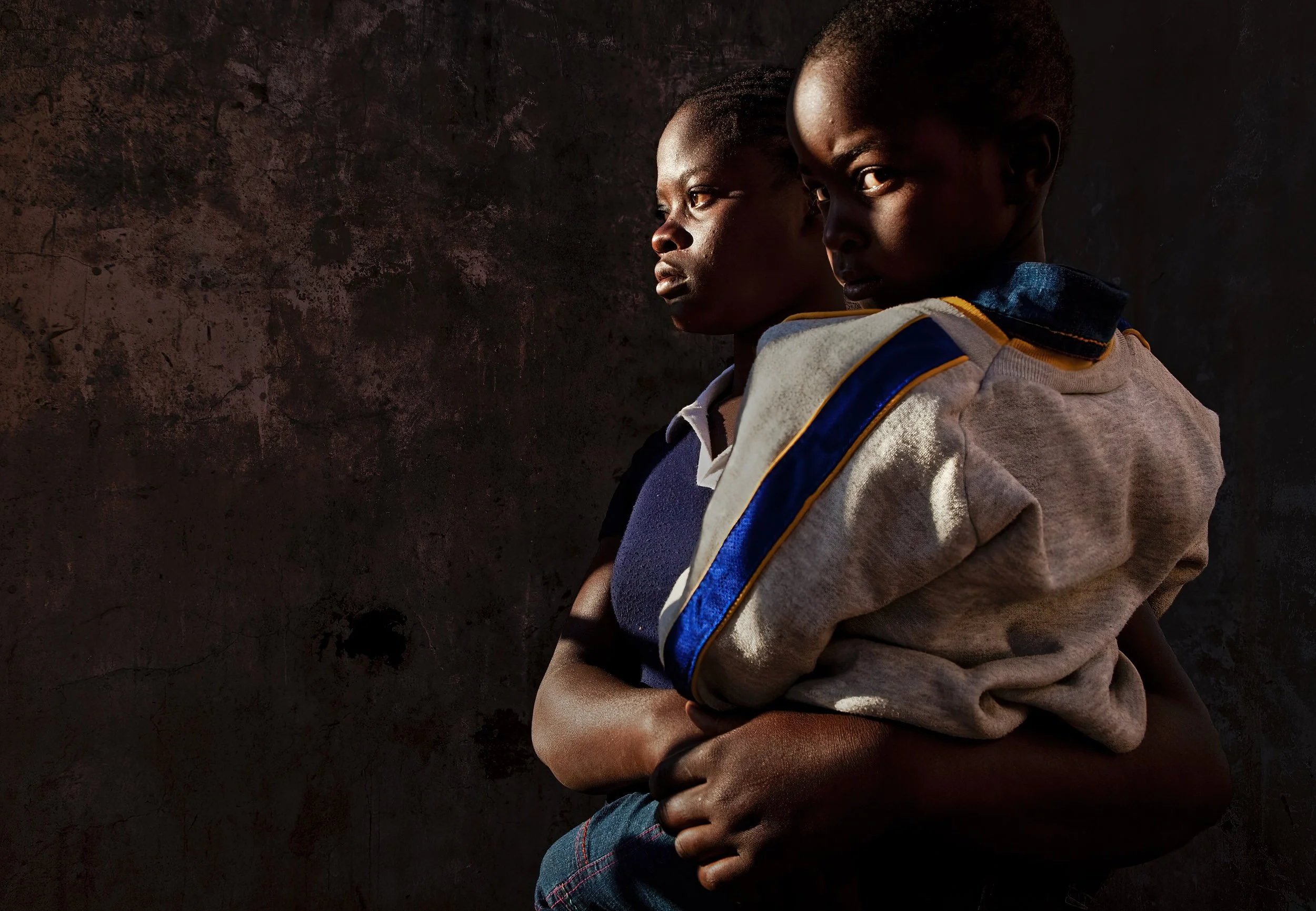 ZAKA, ZIMBABWE, JUNE 2009: A young widow holds her child in a house destroyed by Zanu PF in a rural area of Zaka, Zimbabwe, 24 June 2009. She lost her husband at the conclusion of 2008's March elections in Zimbabwe where the MDC emerged the winner.