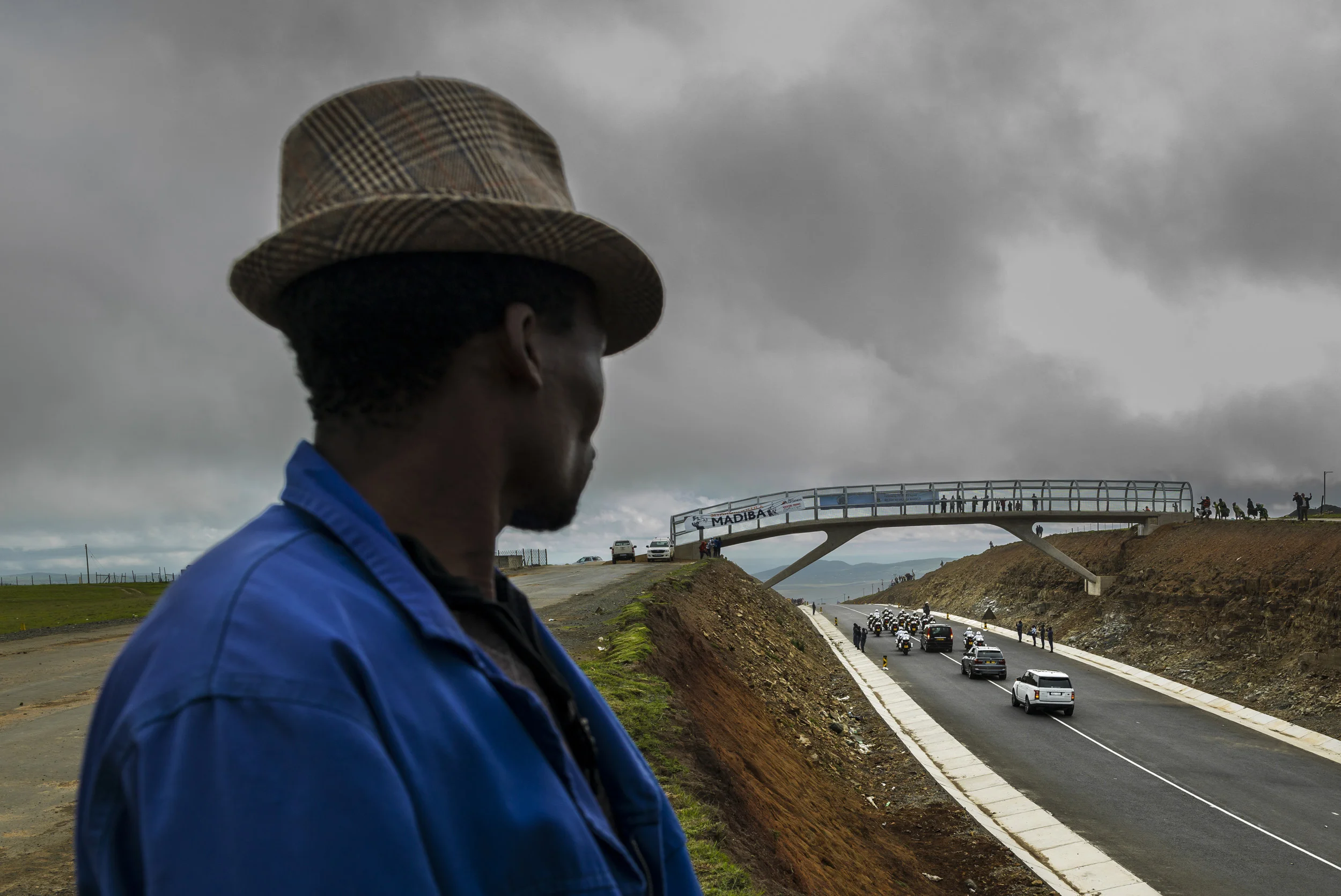QUNU, EASTERN CAPE, SOUTH AFRICA, 14 DECEMBER 2013: A man waits for the Nelson Mandela funeral procession to pass, Qunu, South Africa, 14 December 2014. An icon of democracy, Mandela was buried at his family home in Qunu after passing away on the 5t