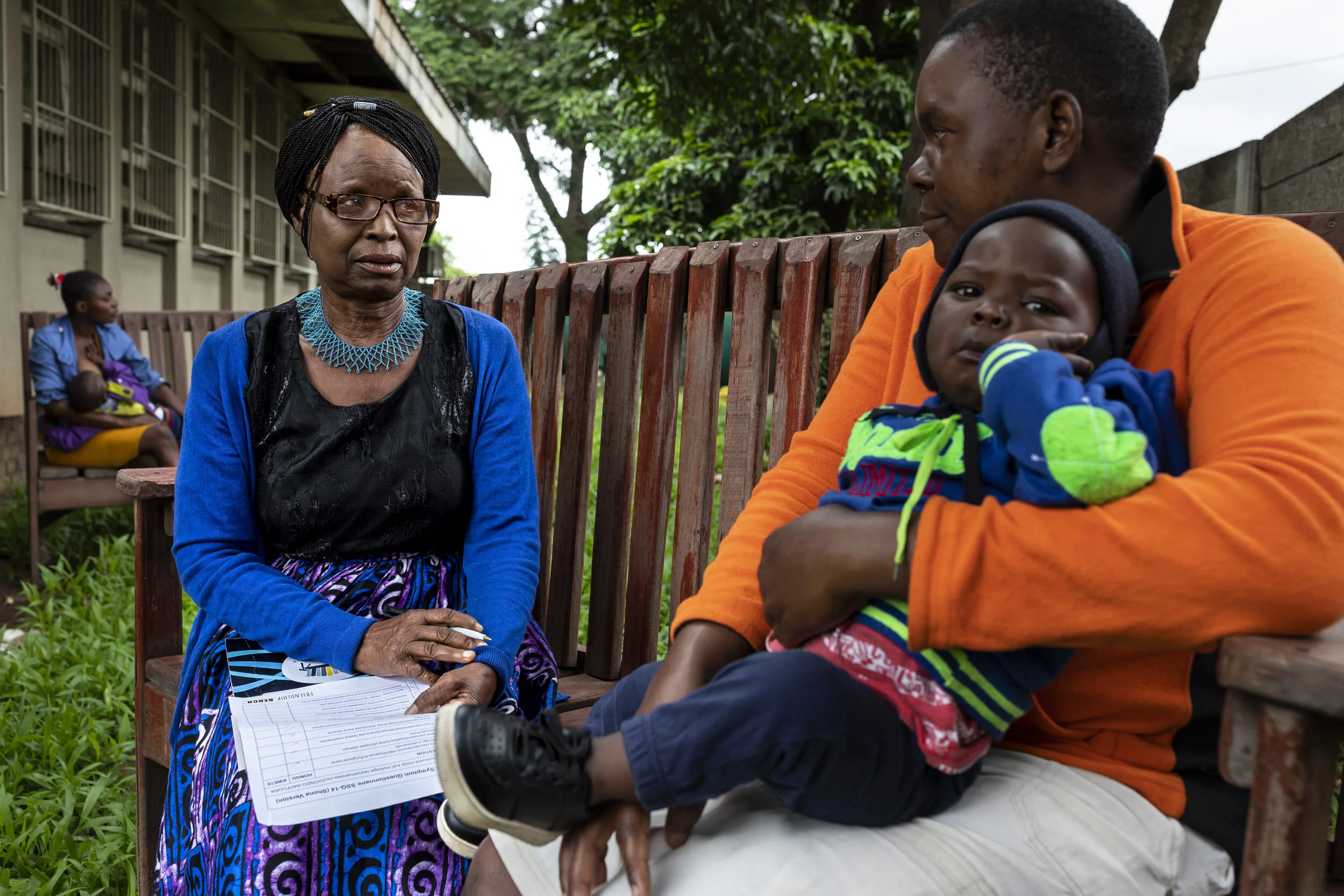 MBARE, HARARE, ZIMBABWE, 21 JANUARY 2020: Juliet Kusikwenyu, 66, works as a mental health counsellor for Friendship Benches, are seen in a counselling session on the benches at Mbare Poly Clinic. The patient in this case is someone who is dealing wi