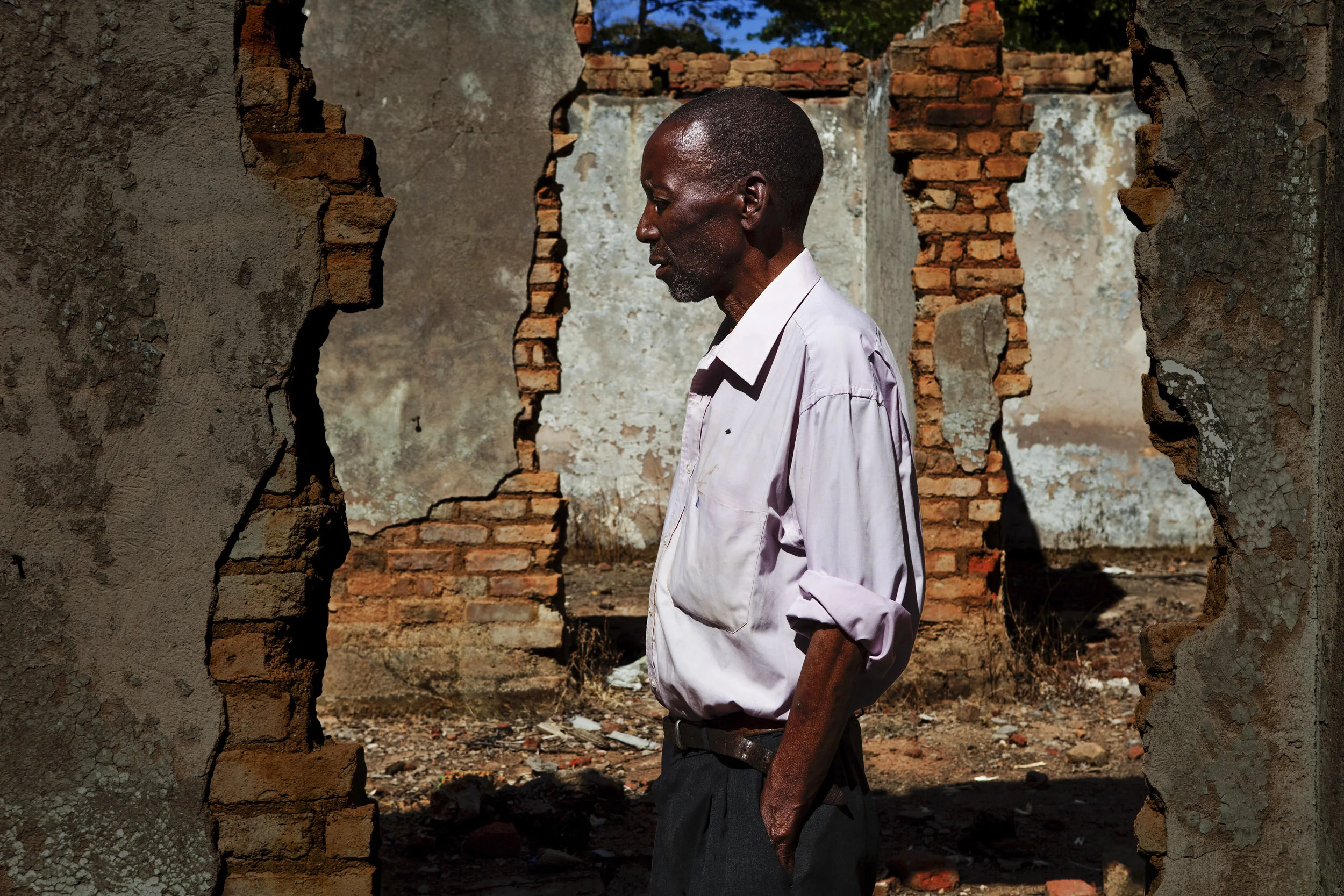 MAZVINGA, ZIMBABWE, JUNE 2009: An elderly man, name withheld, stands in the ruins of his home after it was torched by Zanu PF militias, Mazvinga, Zimbabwe, 21 June 2009. The man is a former civil servant who heard Zanu PF members discussing the farm