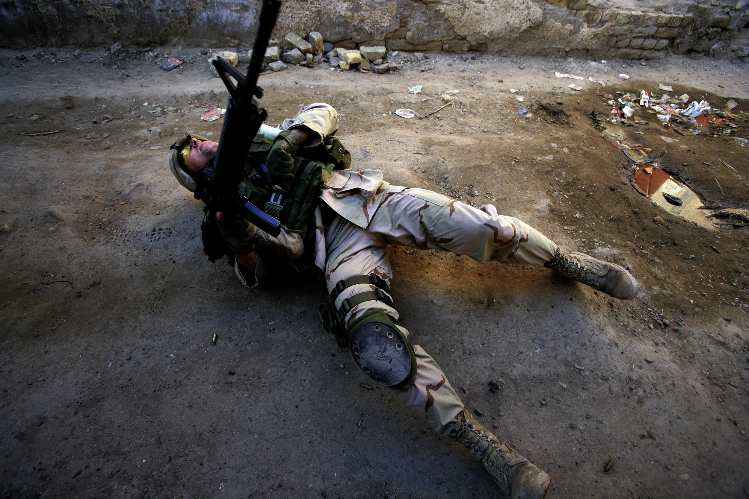 BAGHDAD, IRAQ - 16 FEBRUARY 2005. First Segeant Troy Hawkins falls wounded to the ground during a firefight in the troubled Haifa street area of Baghdad. Sgt Hawkins was wounded in the leg and shoulder but continued to direct troop movement before w