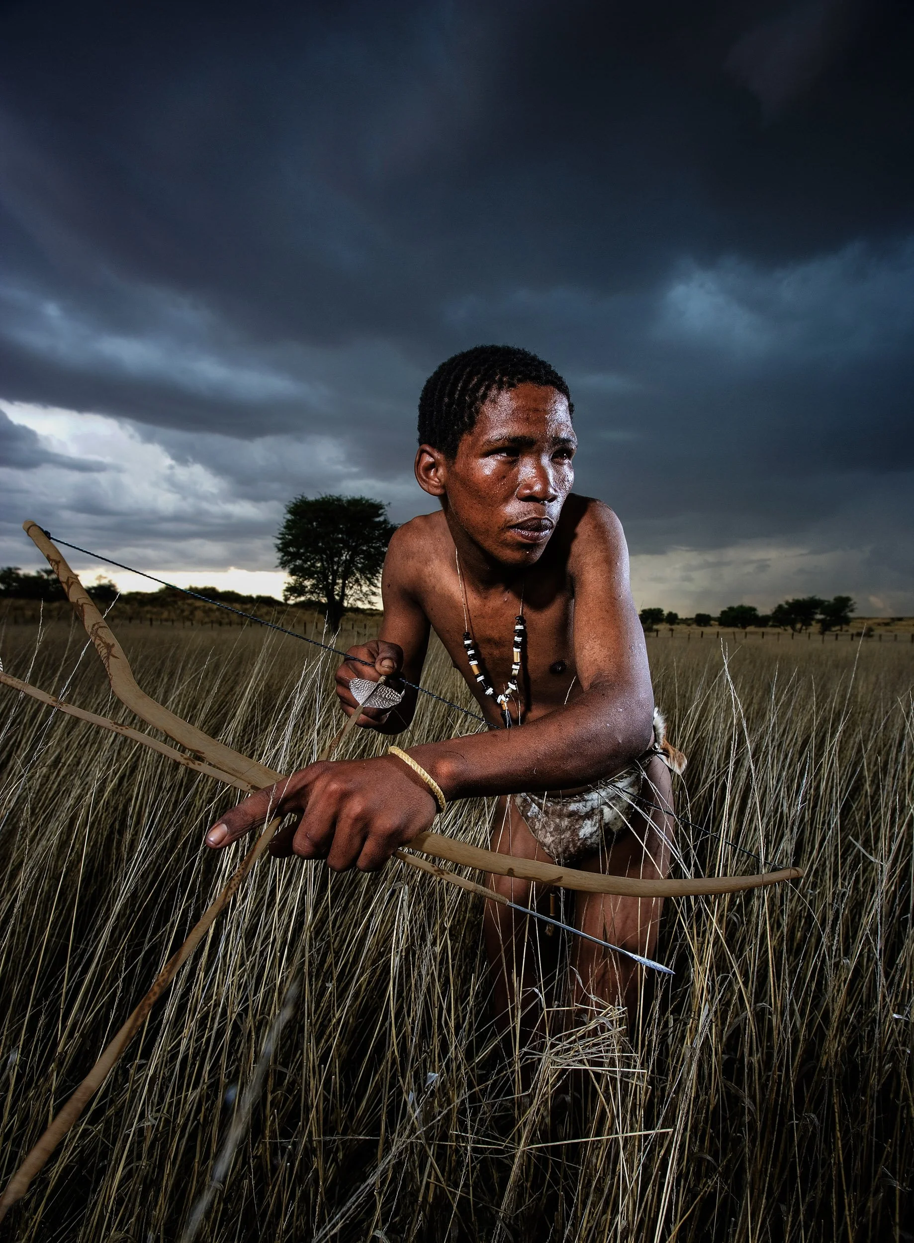 KALAHARI DESERT, SOUTH AFRICA: A San bushman pretends to hunt for a documentary for the Discovery Channel. This man lives in Kalahari Gemsbok National Park where he and his group are part of the tourism attraction of the park. They will occasionally