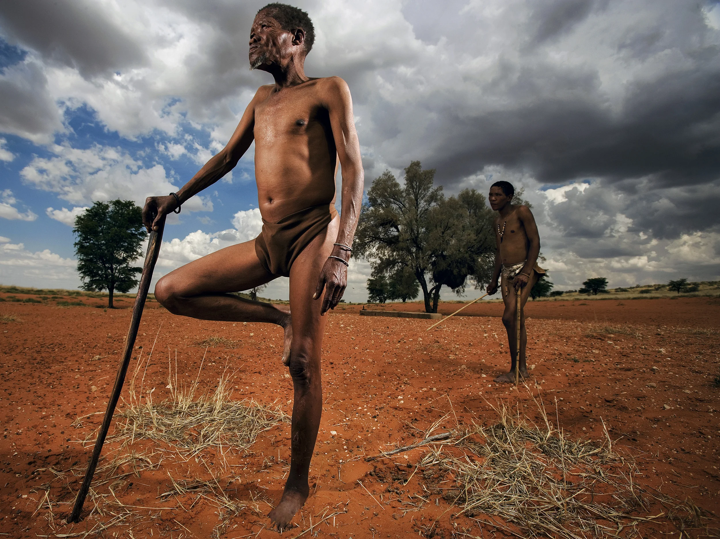 A bushmen and his son take a break while walking through a farm that used to be part of their traditional hunting ground. The Bushmen are regarded by historians as the first people of South Africa yet they are the most marginalized people in the cou
