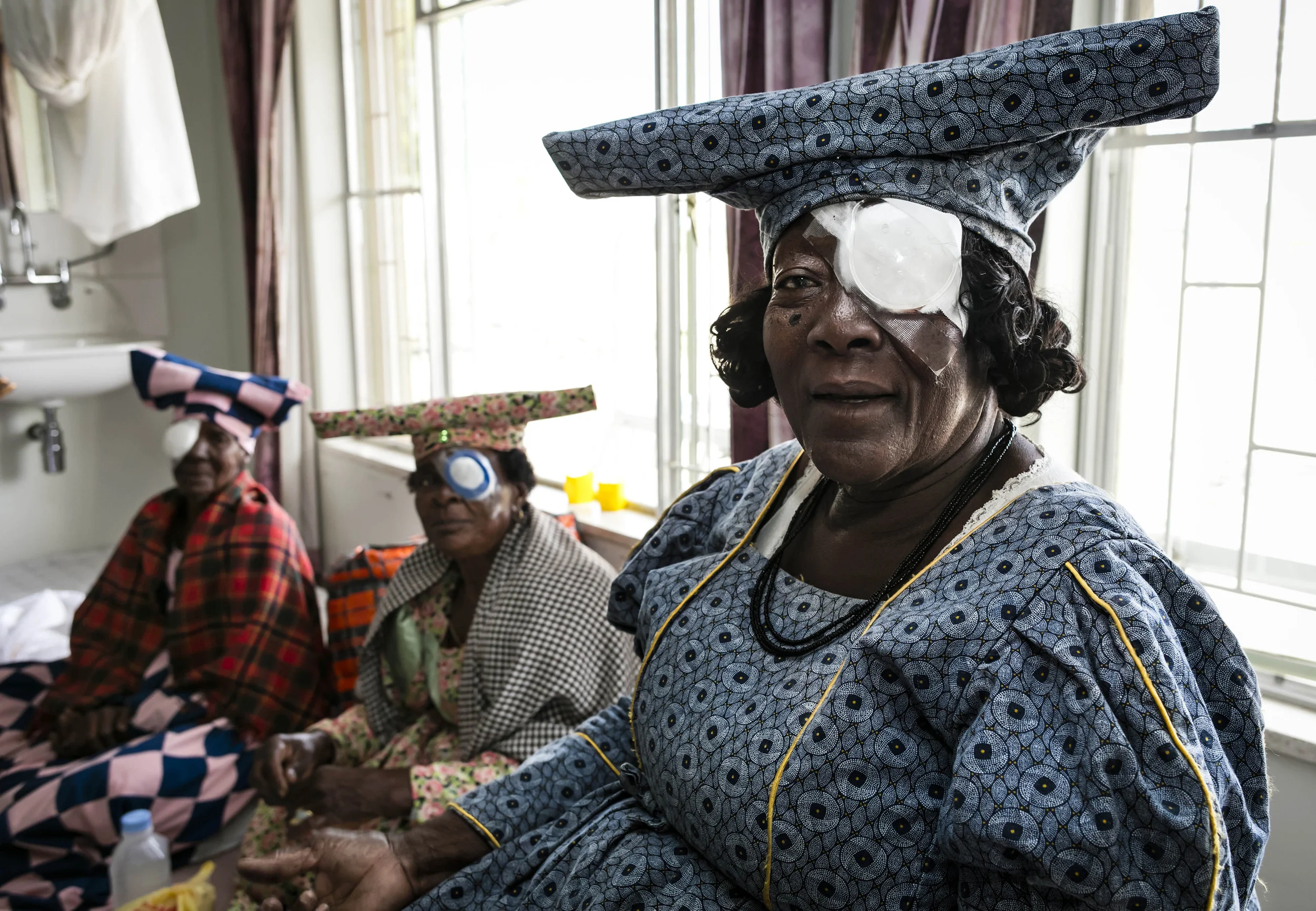 OMARURU, NAMIBIA, 4 November 2015: Herero women waits for their bandages to be removed after undergoing cataract surgery the previous day at Omaruru District Hospital. Most of the people who undergo this kind of eye surgery will recover a degree of