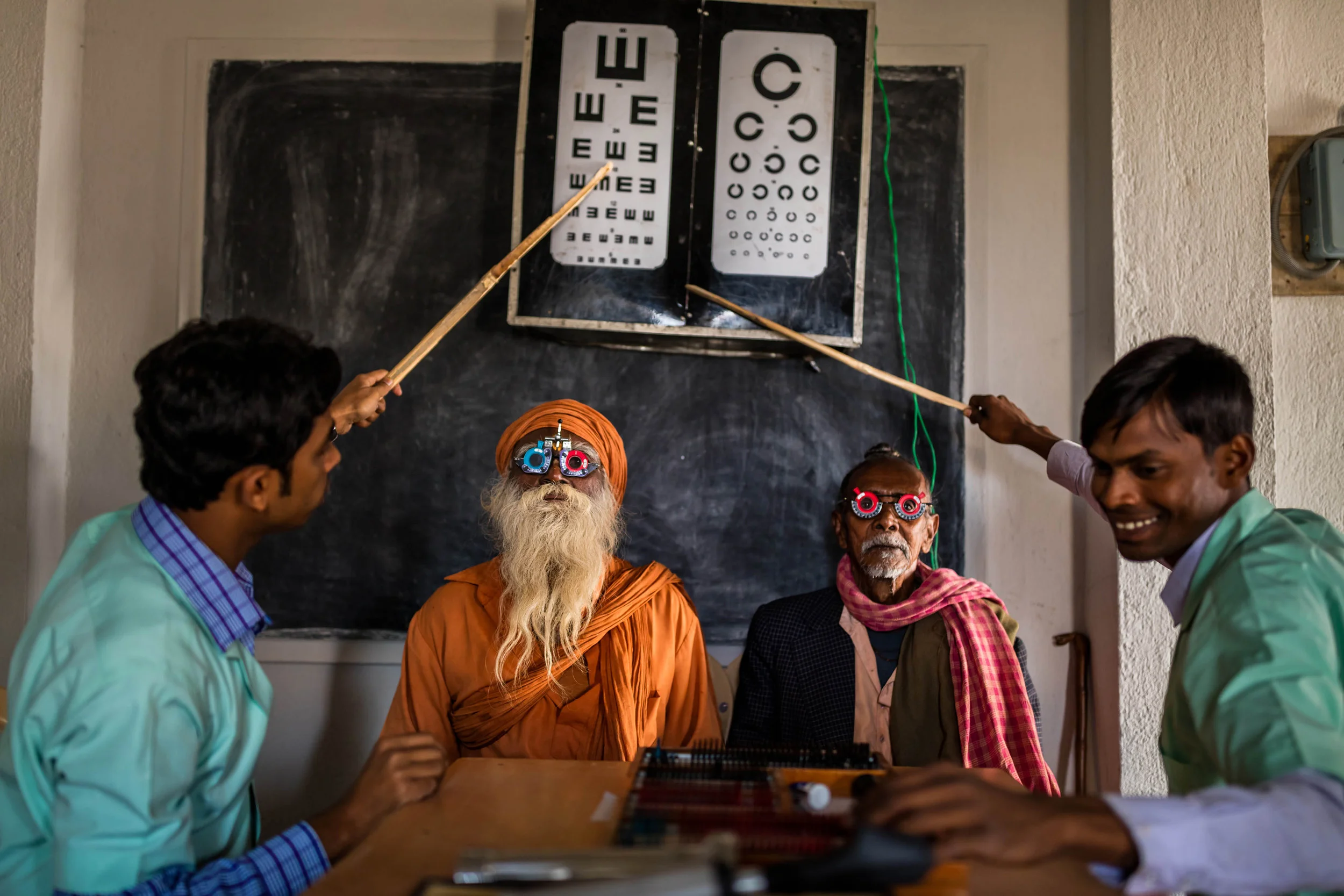 Sundarbans, India: Two Indian gentlemen receive an eye test in a remote part of the Sundarban islands, India. These remote mobile camps offer eye health diagnosis for the first time to extremely impoverished villages deep within the Sundarban island