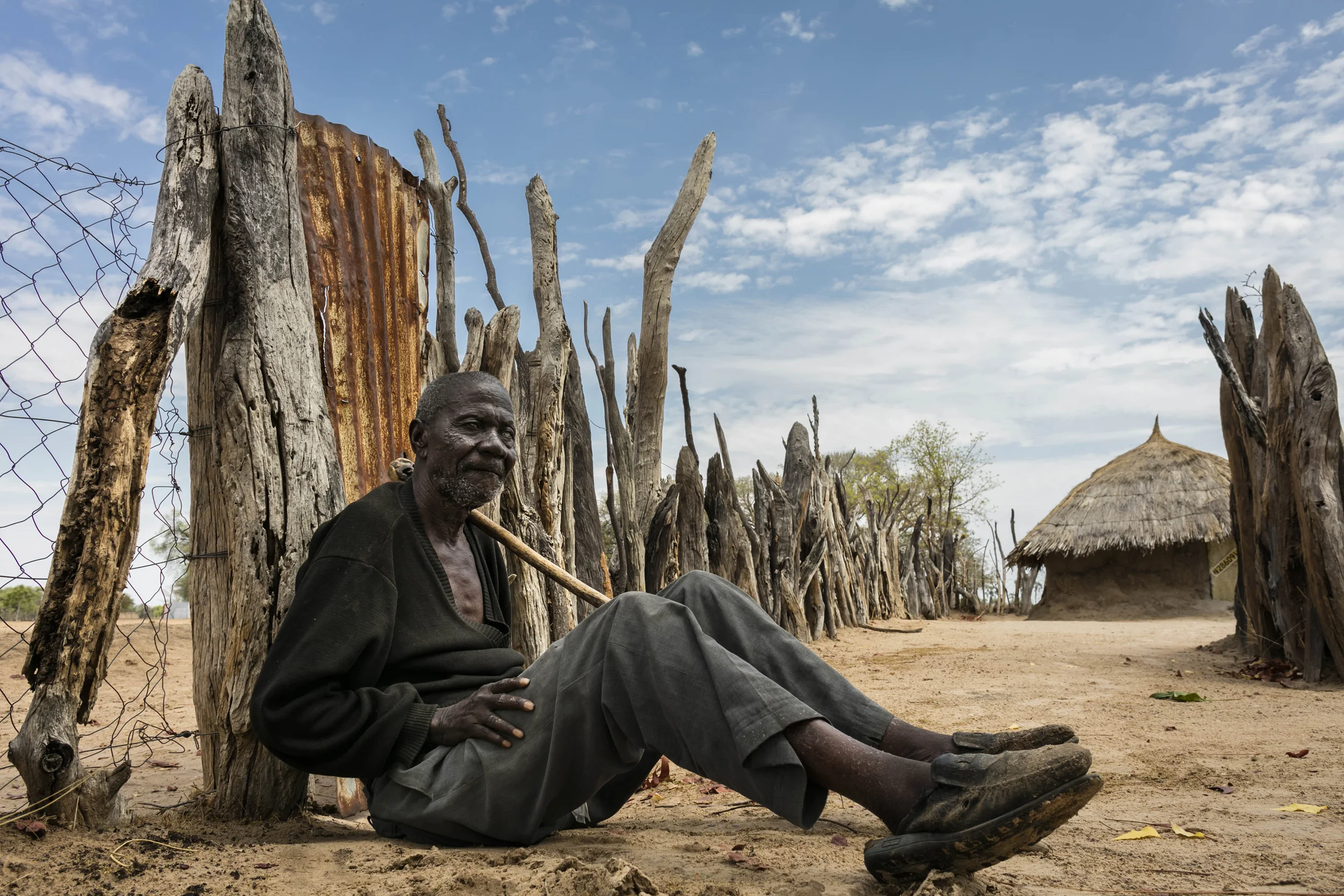 OHANGWENA DISTRICT, NORTHERN NAMIBIA, 8TH NOVEMBER 2015: Frans Shilongo, 77, waits at the gate to his family compound for his nephew to come home. Frans is blind and entirely dependent on his family for his daily needs. For millions of people around