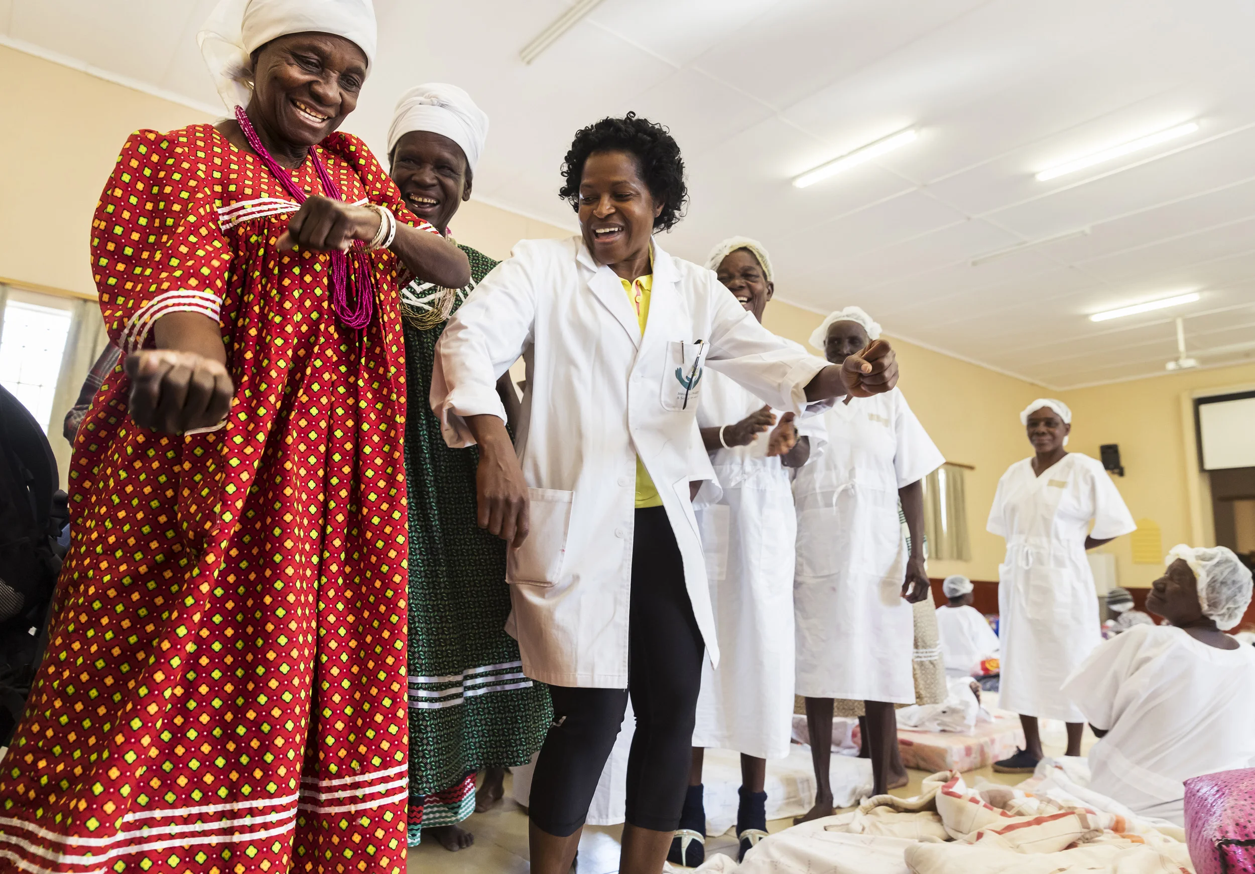 An eye camp for impoverished rural people on the Angolan/Namibian border run by SEE International and Mandela Award winner, Dr Helena Ndume. Patients are seen praising Dr Ndume for her service.