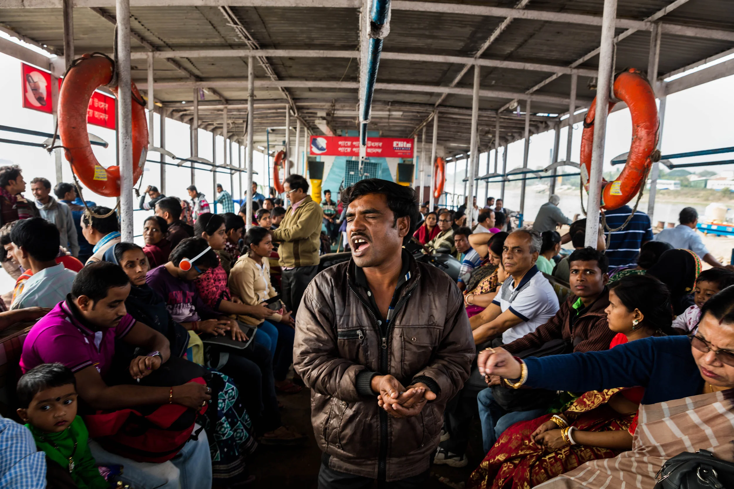 KOLKATA, INDIA, 14 JANUARY 2016: A blind man begs on board a river ferry, he says this is the only kind of job he can get. India has the highest percentage of blind people in the world, about one percent of their population. Most of global blindness