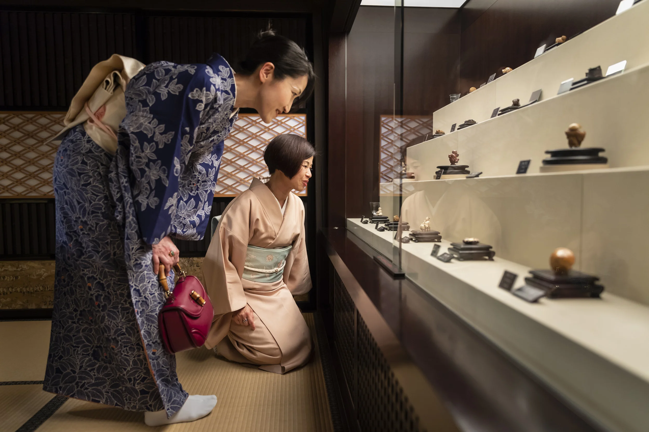 KYOTO, JAPAN, APRIL 2018: Two local Kyoto woman dressed in traditional kimono visit The Netsuke Art Museum, Kyoto. The majority of the high end carvings at the museum are made of ivory, both recent and older carvings. (Photo by Brent Stirton/Verbati