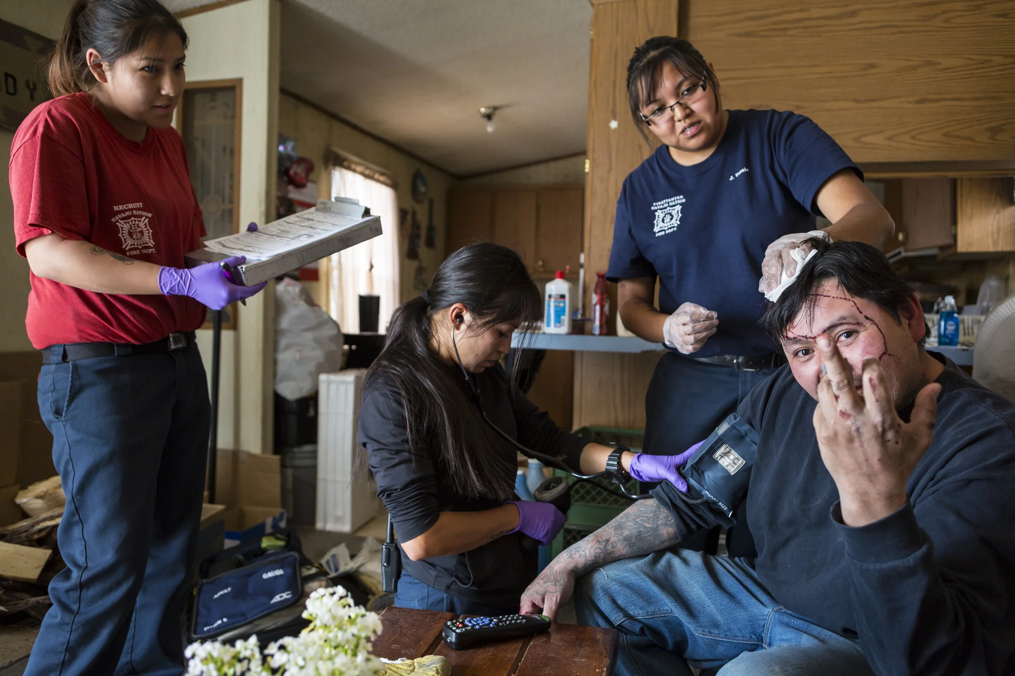 WINDOW ROCK, ARIZONA, 11 APRIL 2014: Navajo EMT emergency workers attend to a man who was assaulted by his brother in WindowRock, Arizona. both were intoxicated at the time, alcohol is illegal on the Navajo reservation but is the chief cause of viol