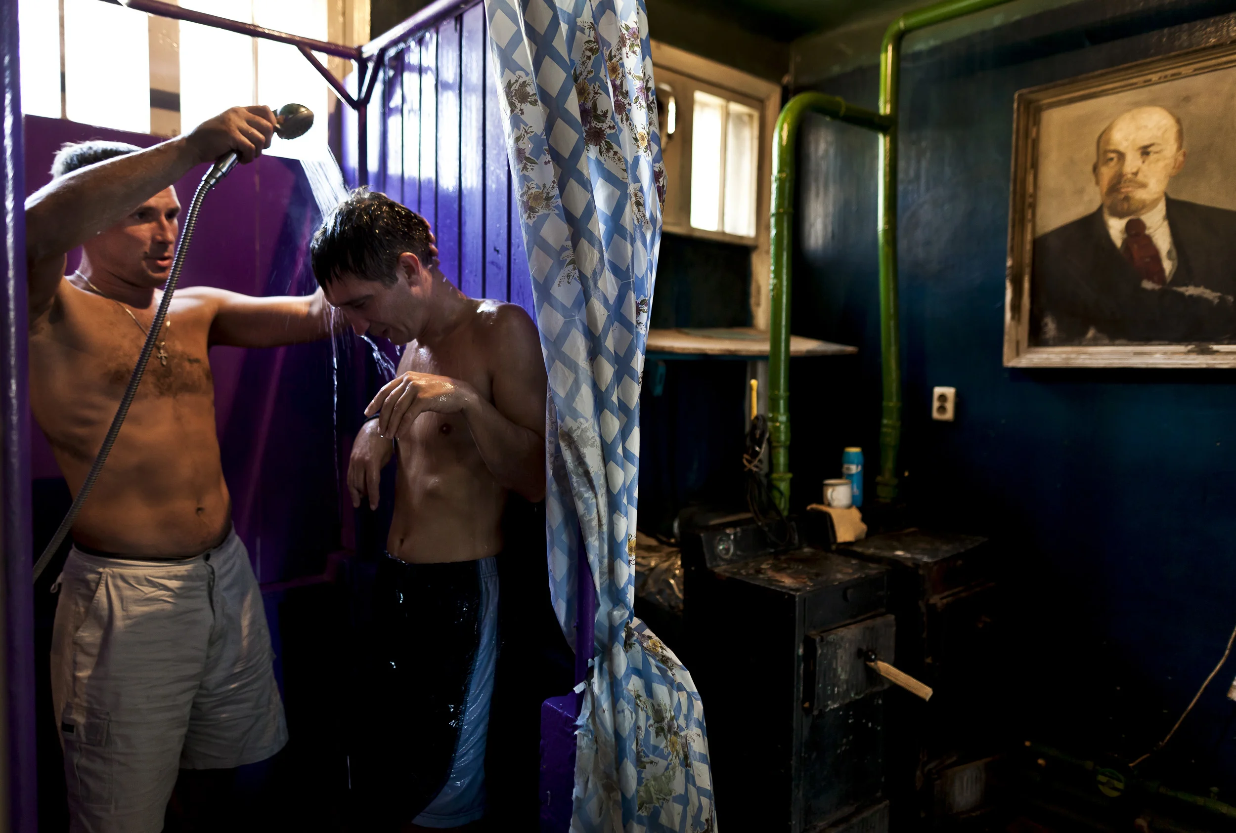 KHARKOV, UKRAINE, AUGUST 2011: Sergei helps his partially paralysed friend Volver to shower at a rehabilitation centre in Kharkov, Ukraine, 29 August 2011. Volver was paralysed when he used a drug made up of Ephedrine and other chemicals which perma
