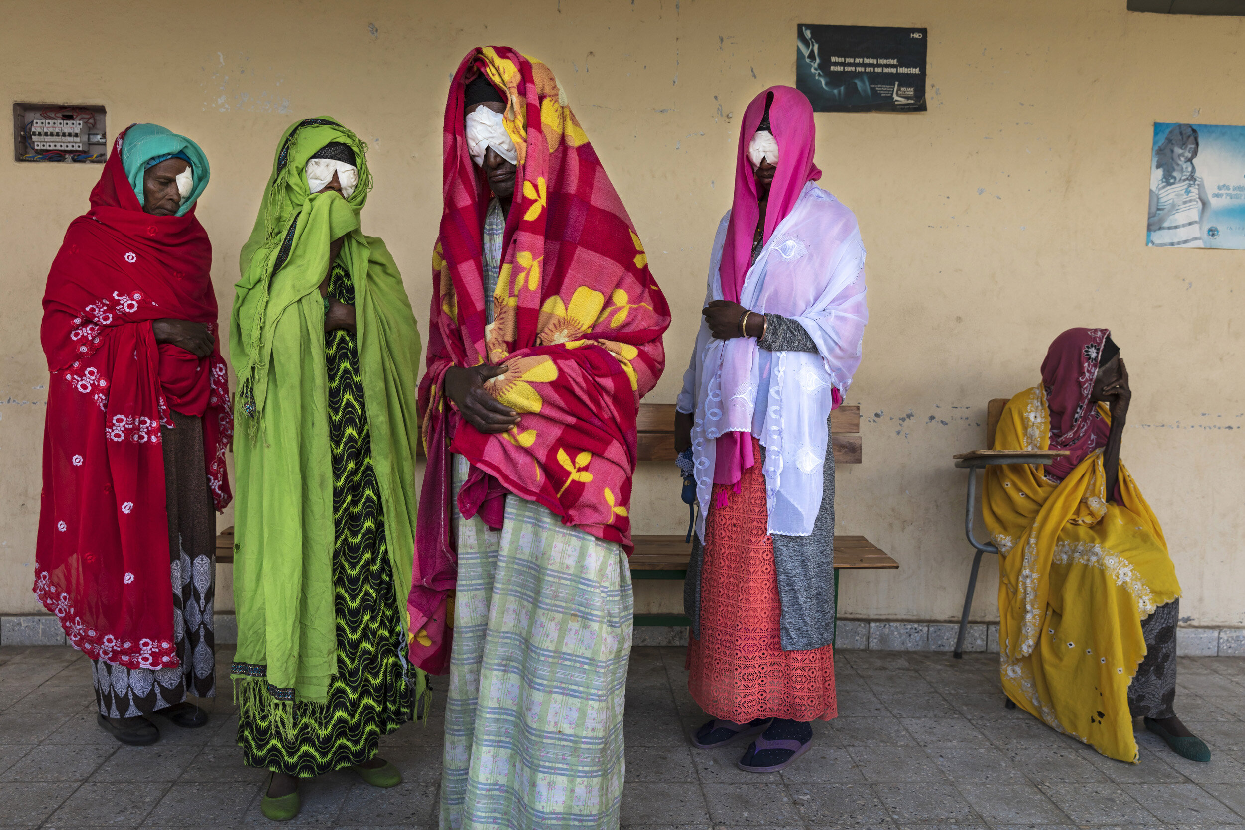 North Mecha Woreda, Amhara region of Ethiopia. A group of five woman all from the same family, all suffering from Trachoma induced blindness. They are waiting to have their eye covering removed after a remote clinic from the Carter foundation reache