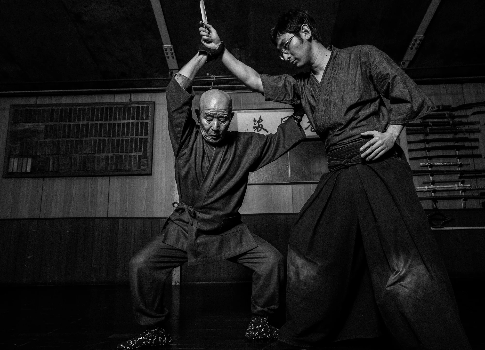 NAGOYA CITY, JAPAN, 17 OCTOBER 2014: Master Sensei Kato, 81, corrects a student's technique at his Nagoya city dojo. Sensei Kato runs the auspicious Owari Kan Ryu school where he himself studied under his master from the age of 25. Kato is a traditi
