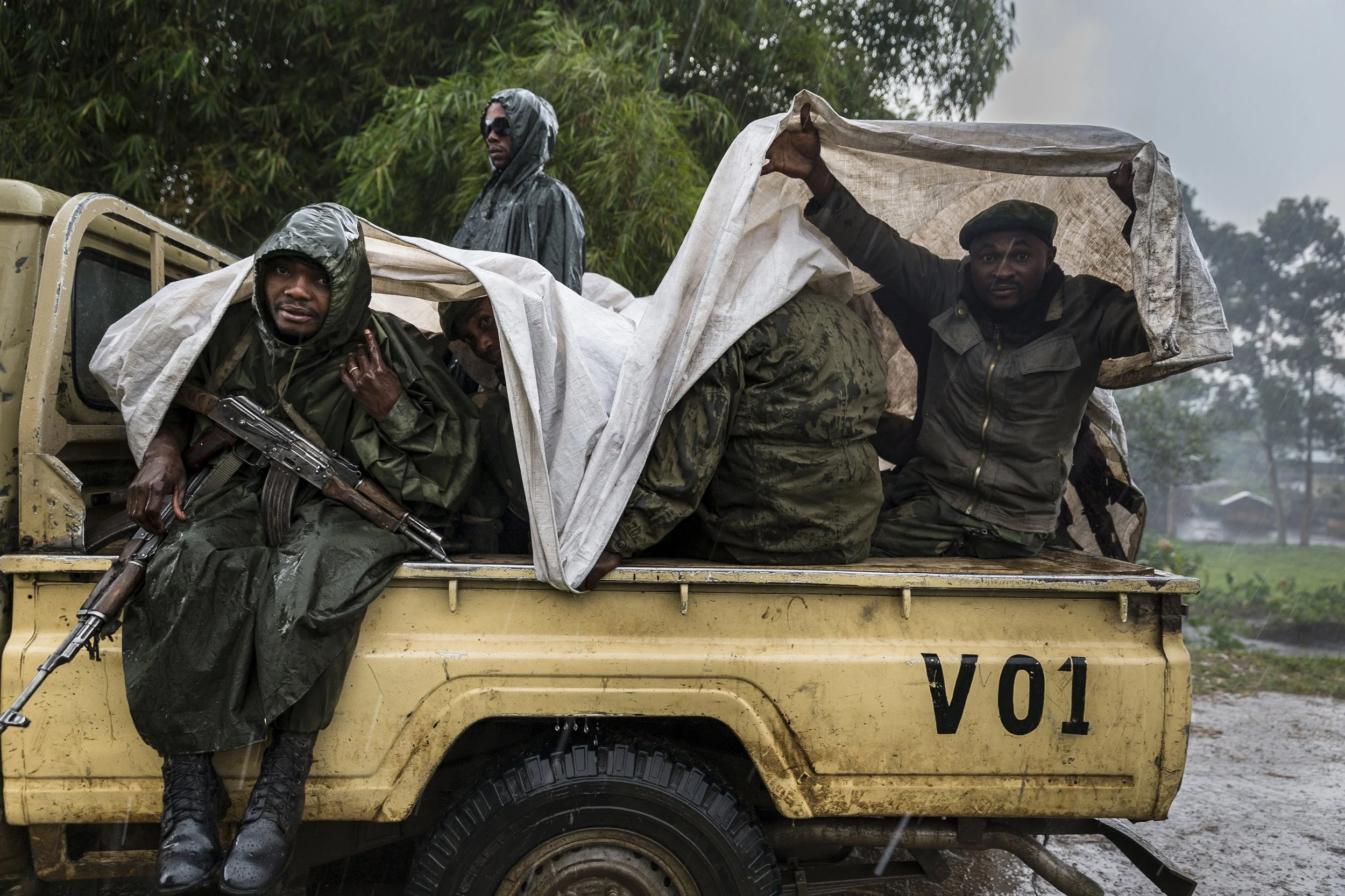 RUMANGABO, EASTERN DEMOCRATIC REPUBLIC OF CONGO, MARCH 2012:ICCN Congolese Conservation Ranger and a few FARDC Congolese Army soldiers prepare for a patrol in the rain in Virunga National Park, DRC, 25 July 2014. (Photo by Brent Stirton/Reportage.)